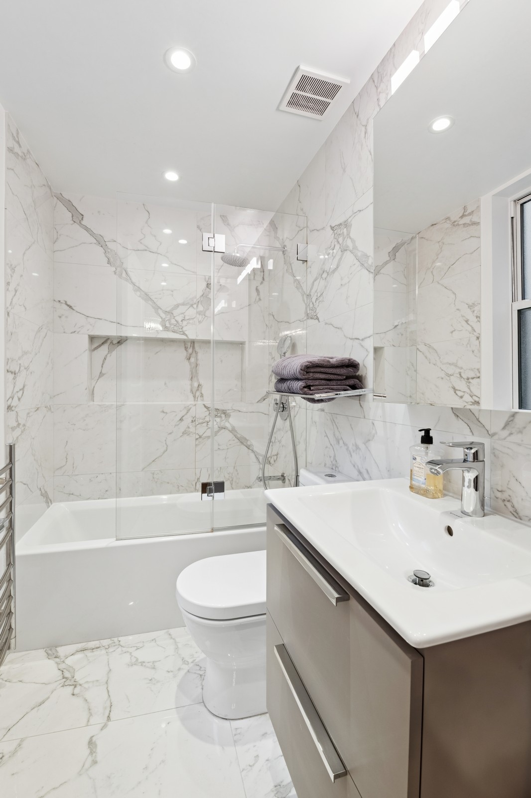 108 East 91st Street, Unit 4B Manhattan, NY 10128 - Photo 8 of 11 a bathroom with a sink a toilet and shower