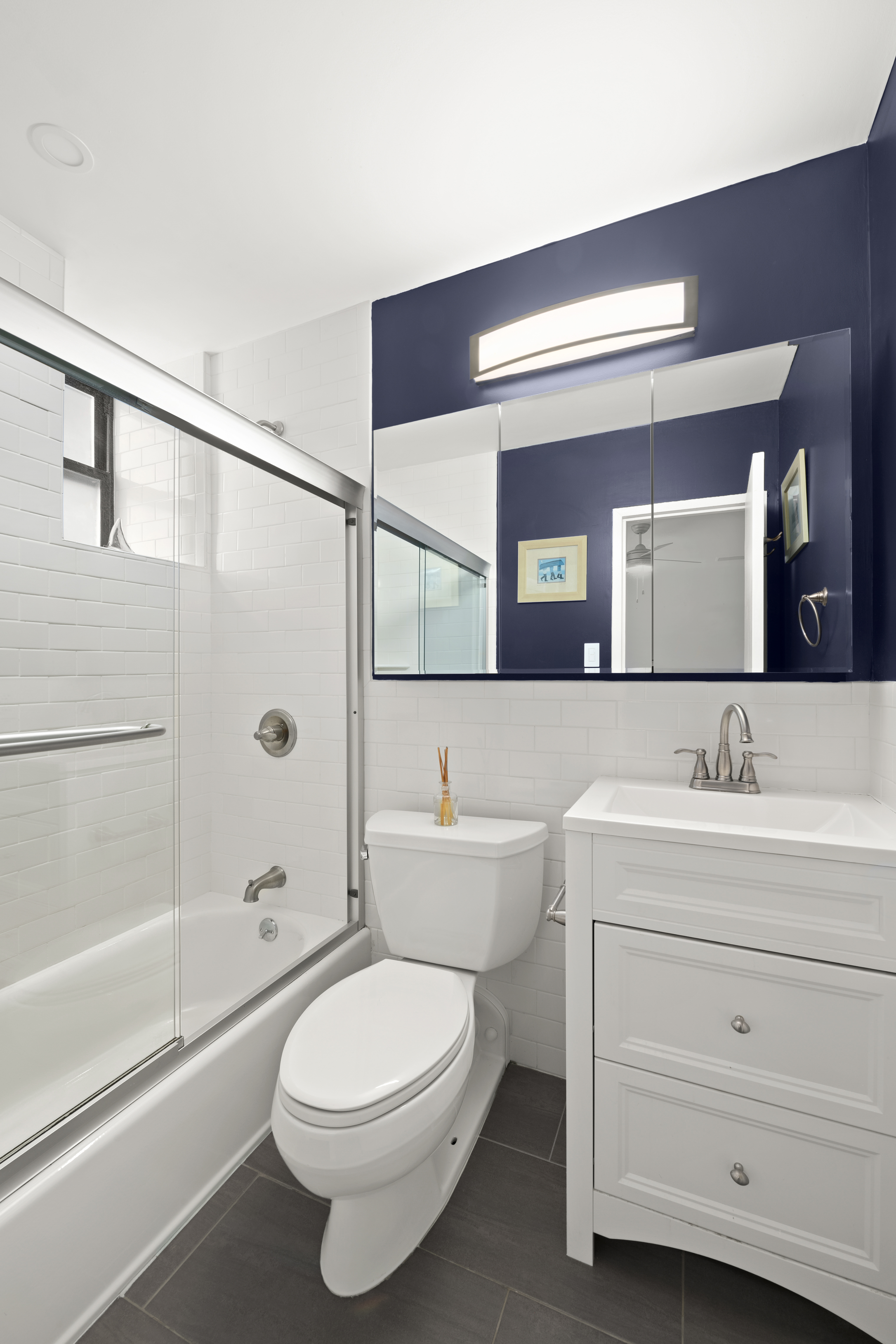 340 West 55th Street, Unit 5C Manhattan, NY 10019 - Photo 7 of 10 a bathroom with a toilet a sink and a bathtub