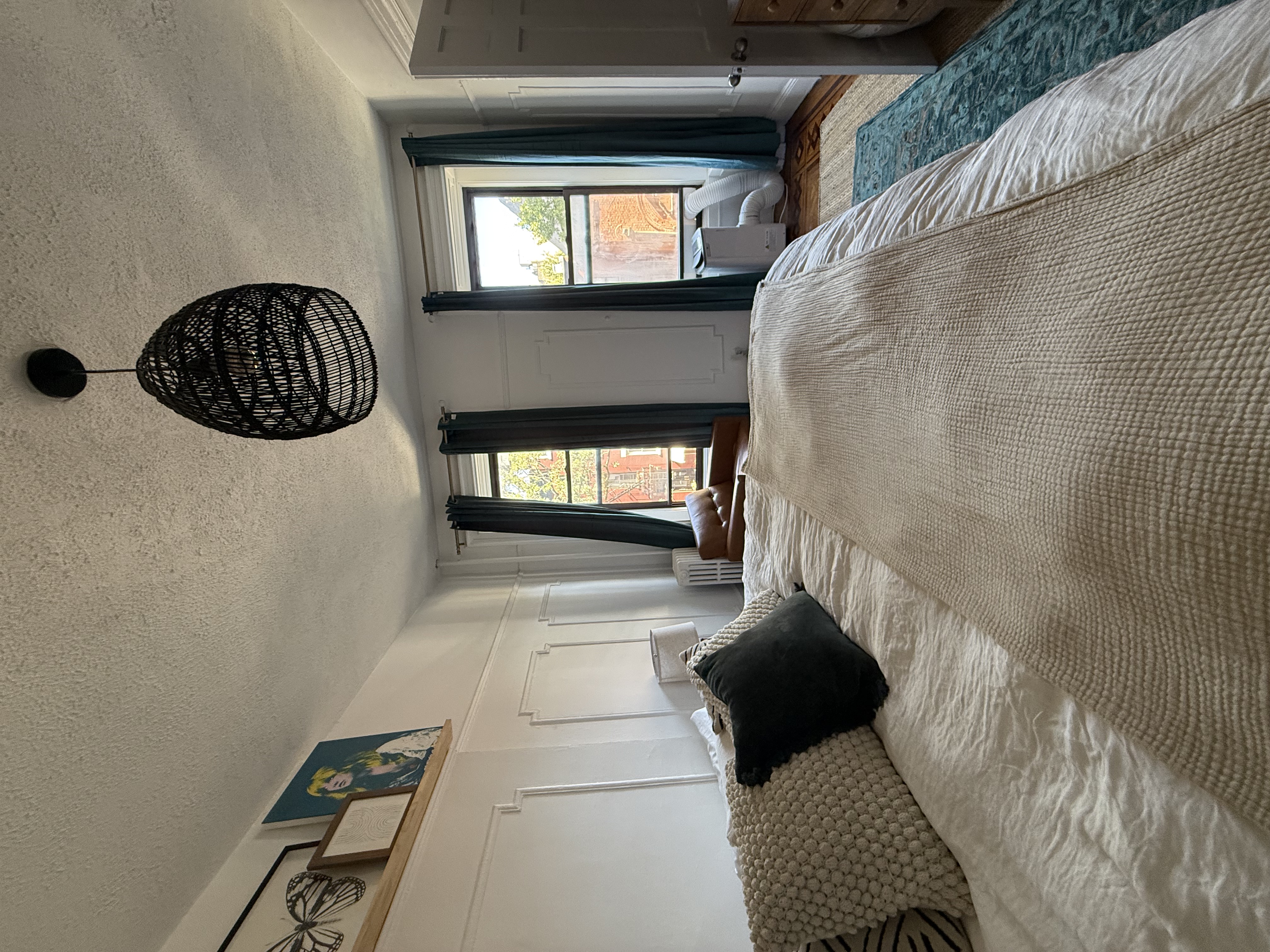 230 17th Street, Unit 2 Brooklyn, NY 11215 - Photo 12 of 16 a large bed sitting in a bedroom next to a window and a chandelier