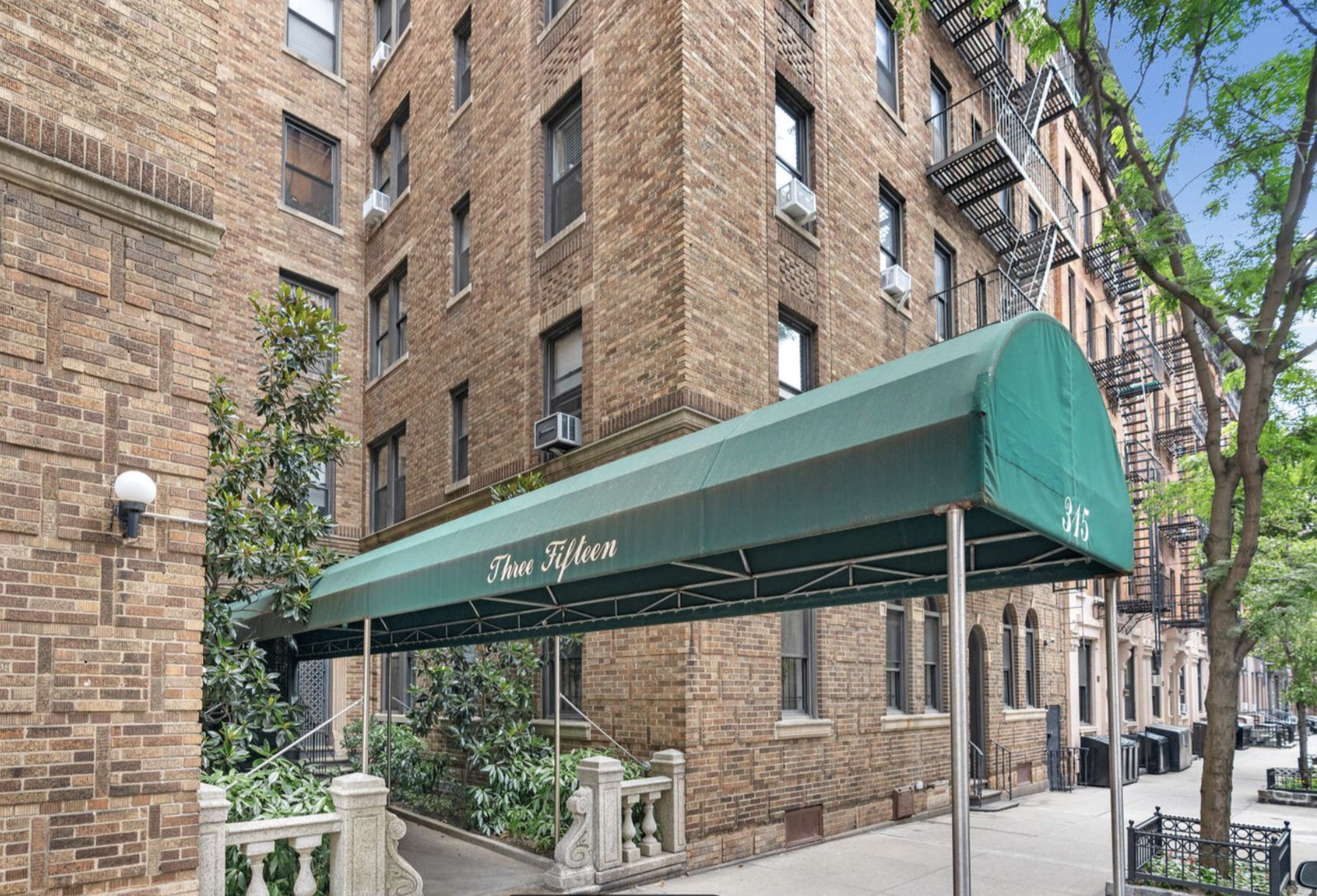 315 East 88th Street, Unit 5E Manhattan, NY 10128 - Photo 7 of 8 a front view of a building with a tree