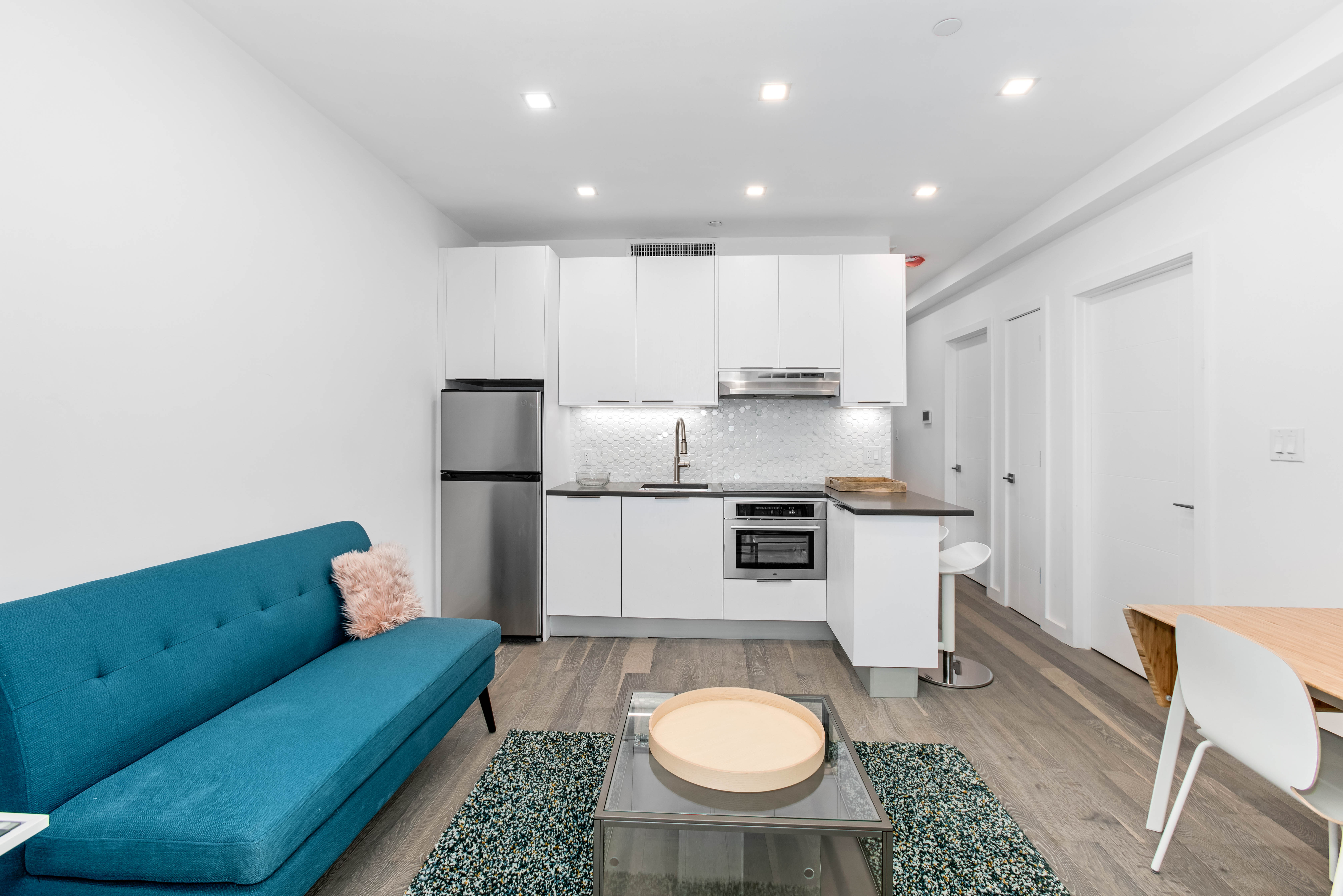 319 Broadway, Unit 6B Brooklyn, NY 11211 - Photo 1 of 5 a kitchen with a dining table chairs and utility