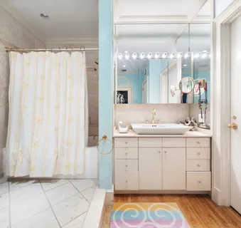 a spacious bathroom with a sink a mirror and a shower