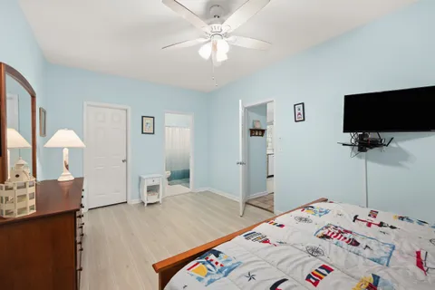 a bedroom with a bed and a flat screen tv
