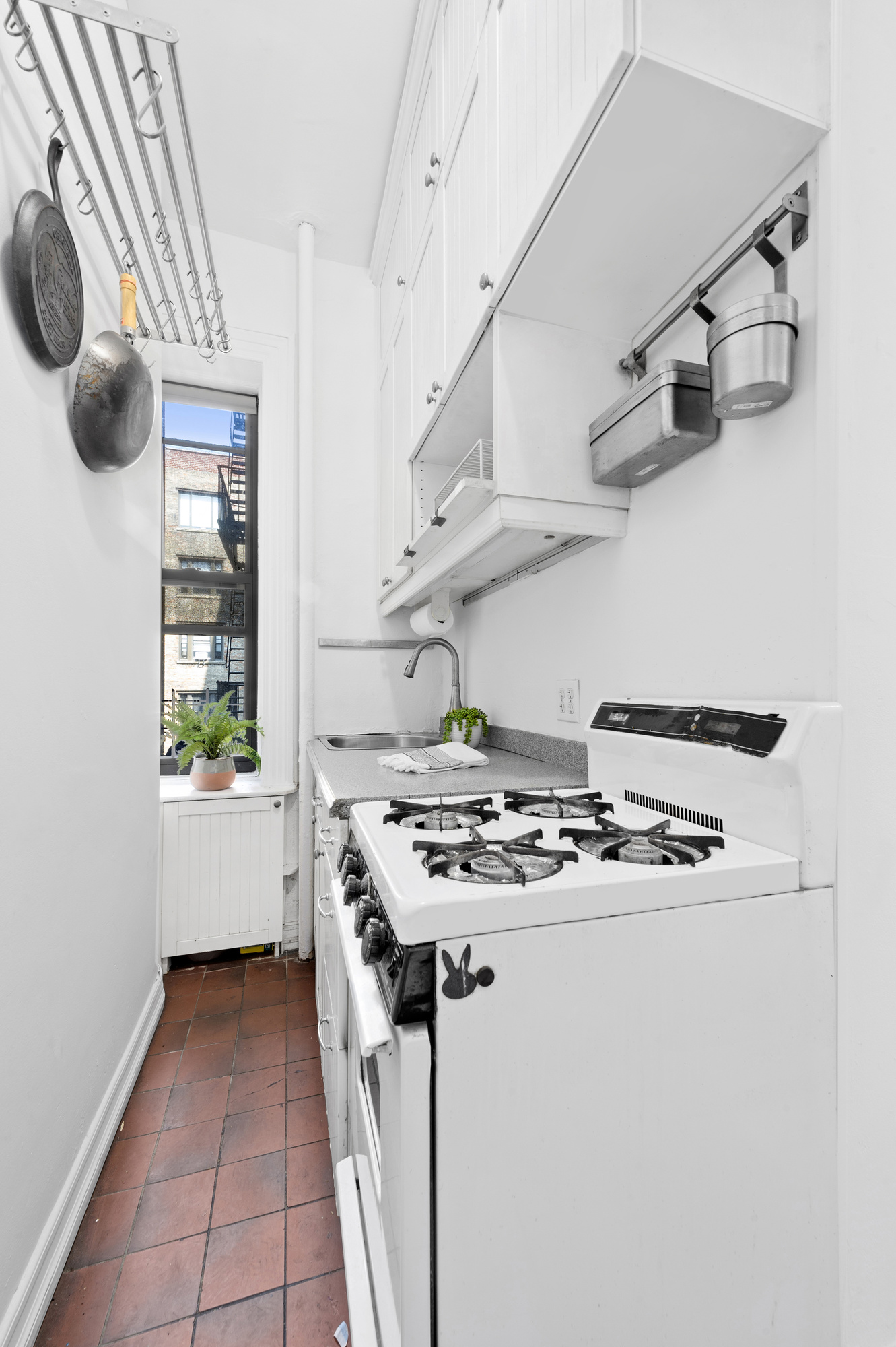 615 West 113th Street, Unit 3132 Manhattan, NY 10025 - Photo 9 of 13 a white stove top oven sitting inside of a kitchen