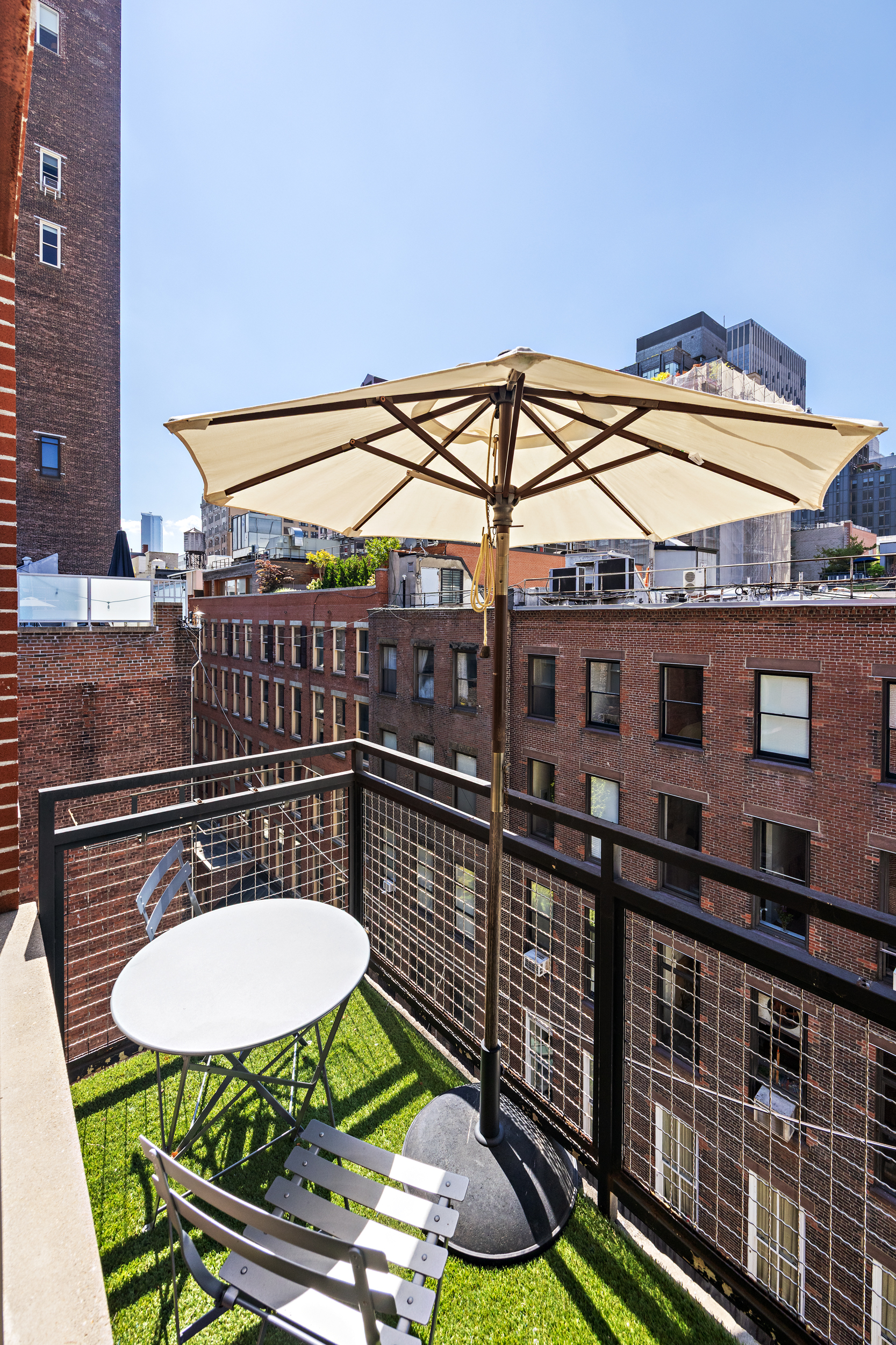 51 Walker Street, Unit 8B Manhattan, NY 10013 - Photo 9 of 16 a view of a balcony with a table and chairs