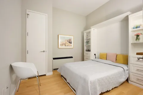 a bedroom with a bed and a chair