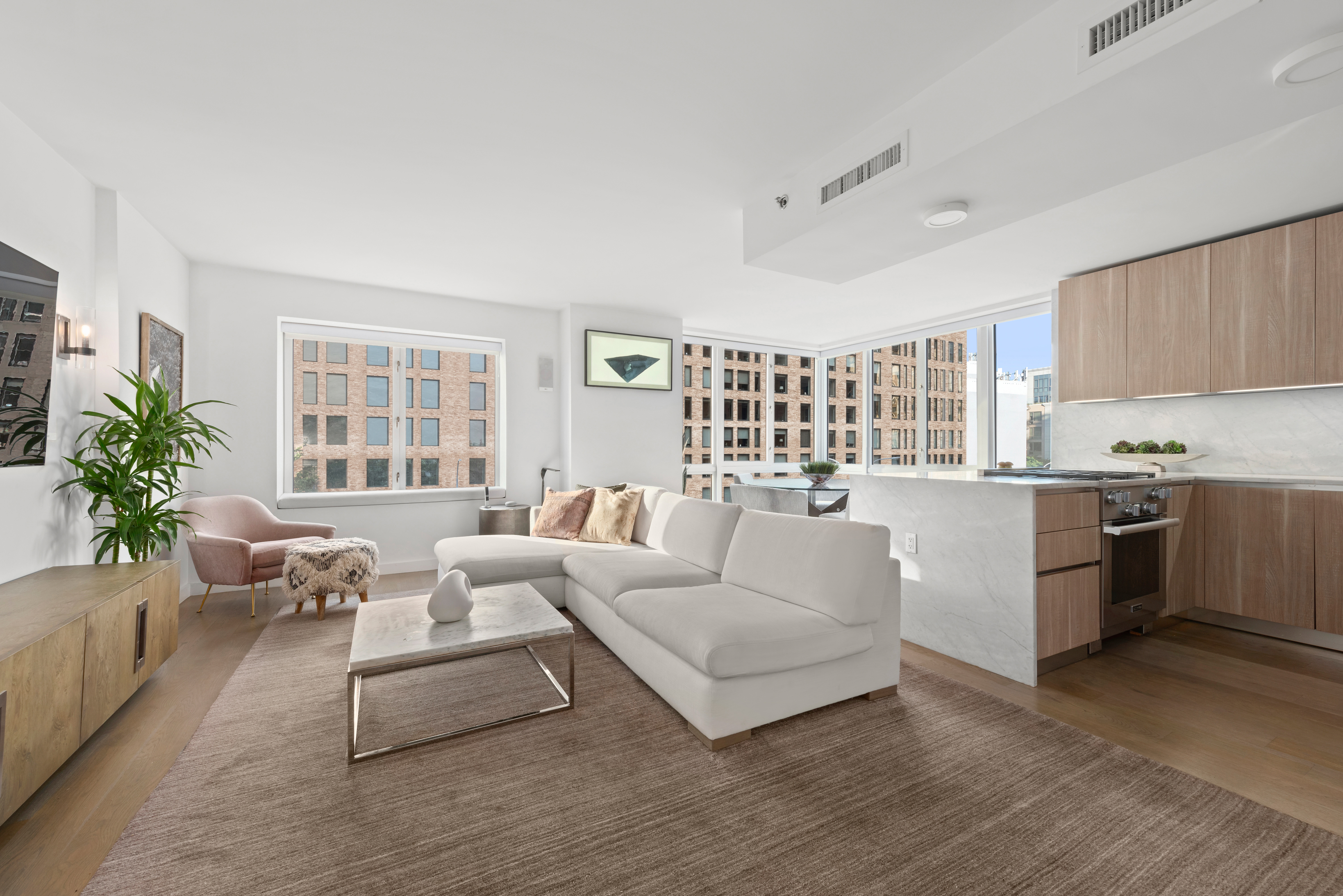 265 East Houston Street, Unit 4 Manhattan, NY 10002 - Photo 1 of 20 a living room with furniture and a large window
