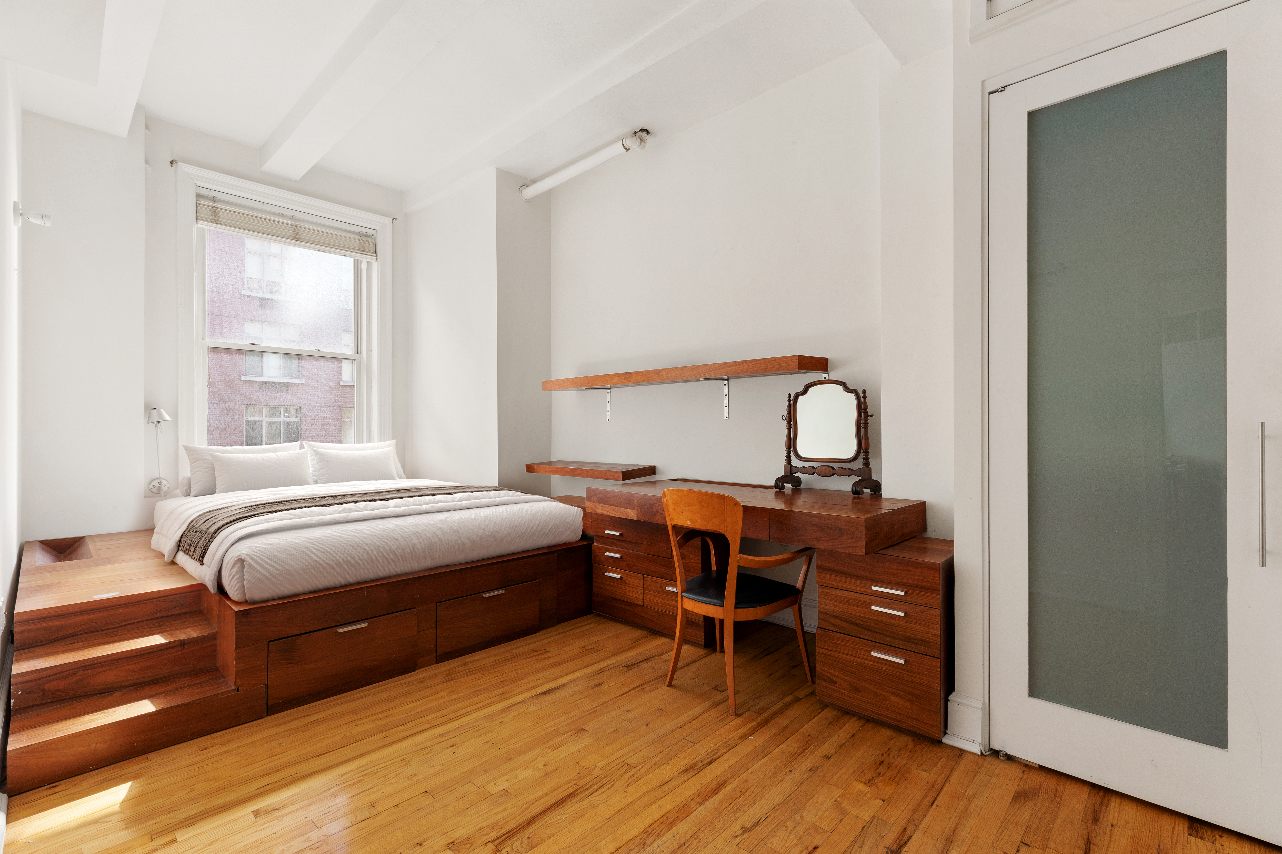 126 West 22nd Street, Unit 5N Manhattan, NY 10011 - Photo 9 of 13 a bedroom with a bed and wooden floor