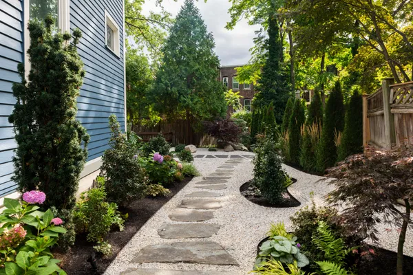 a view of a garden with flowers and trees