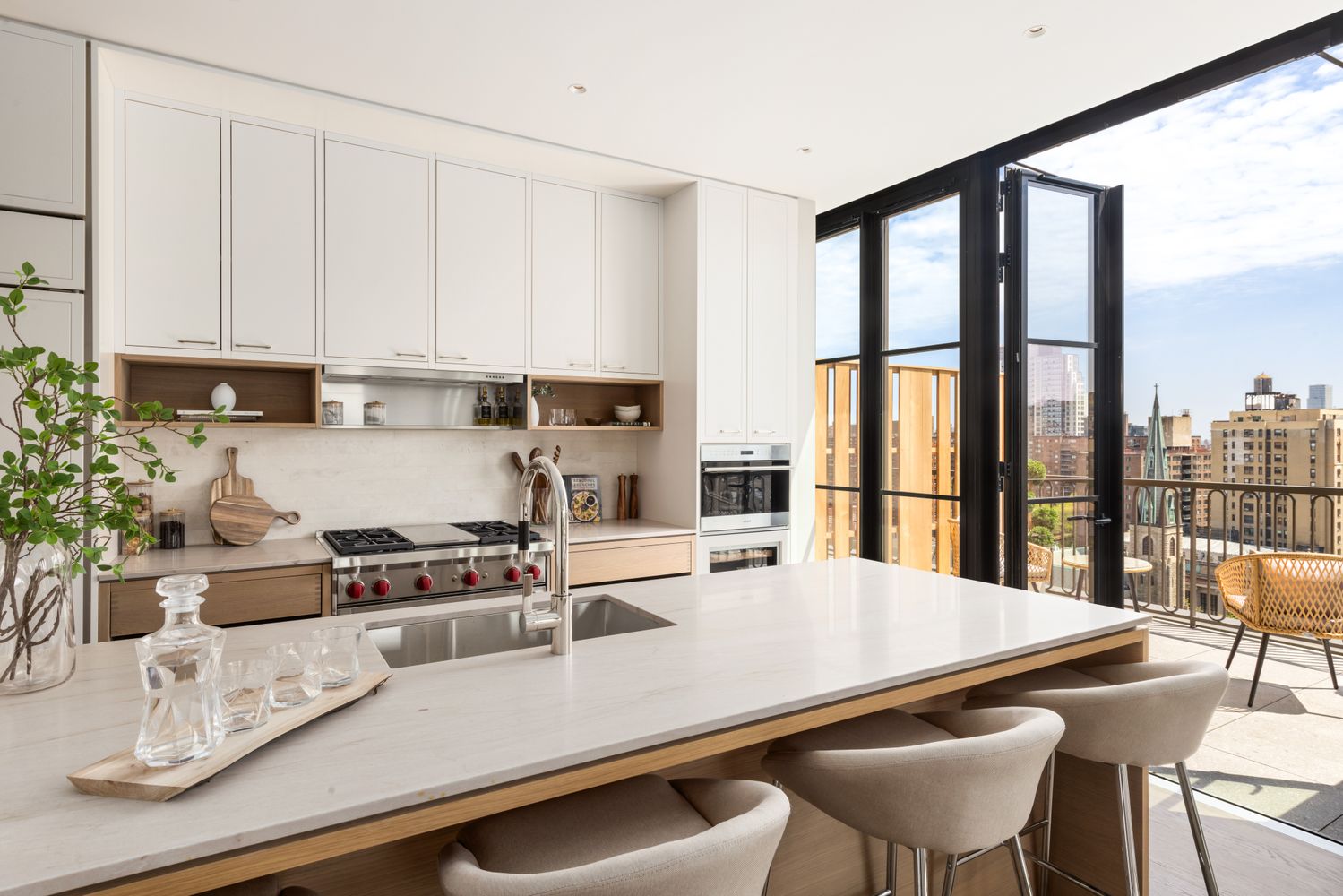 a kitchen with a table chairs and white cabinets