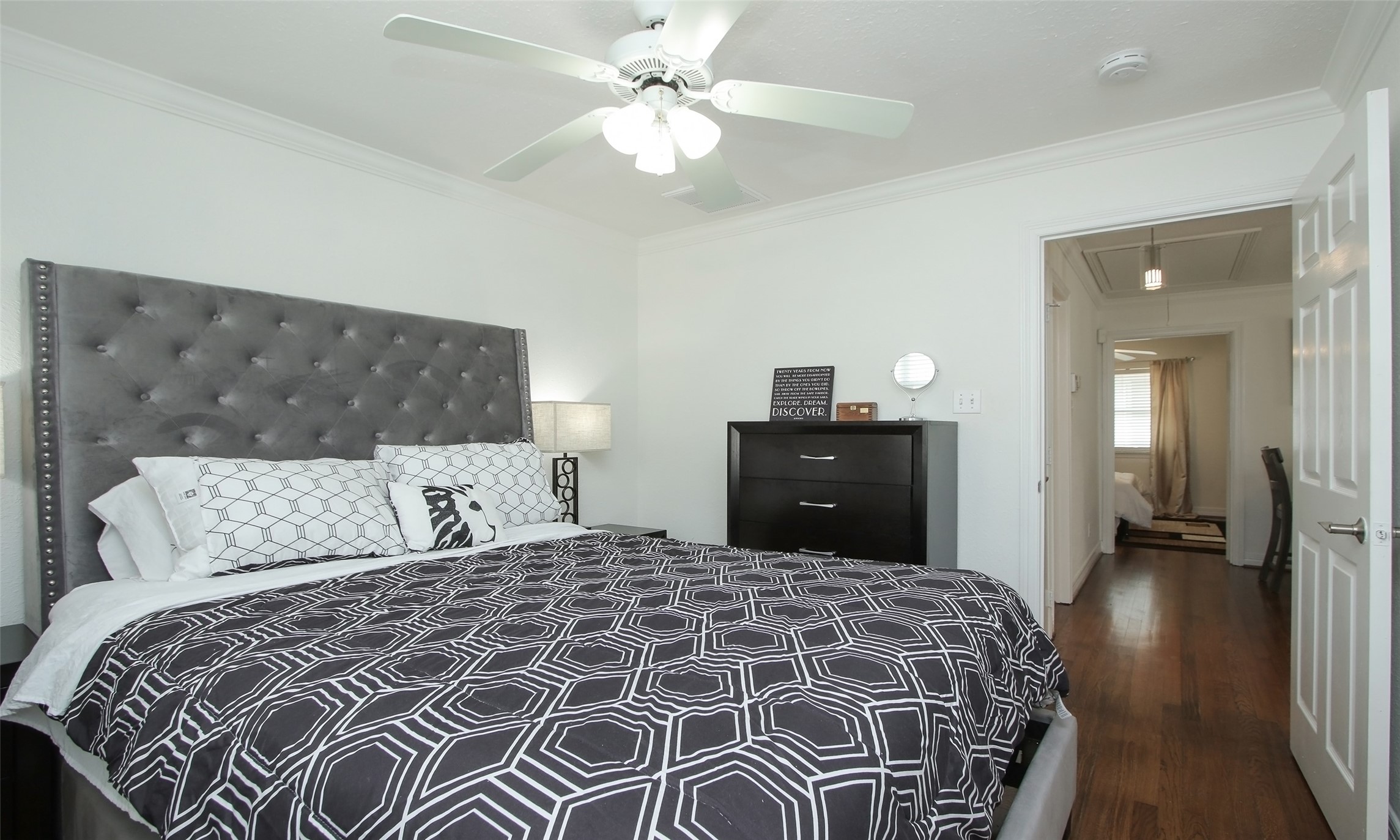 4331 Marina Street, Unit B Houston, TX 77007 - Photo 9 of 37 a bedroom with a large bed and a chandelier