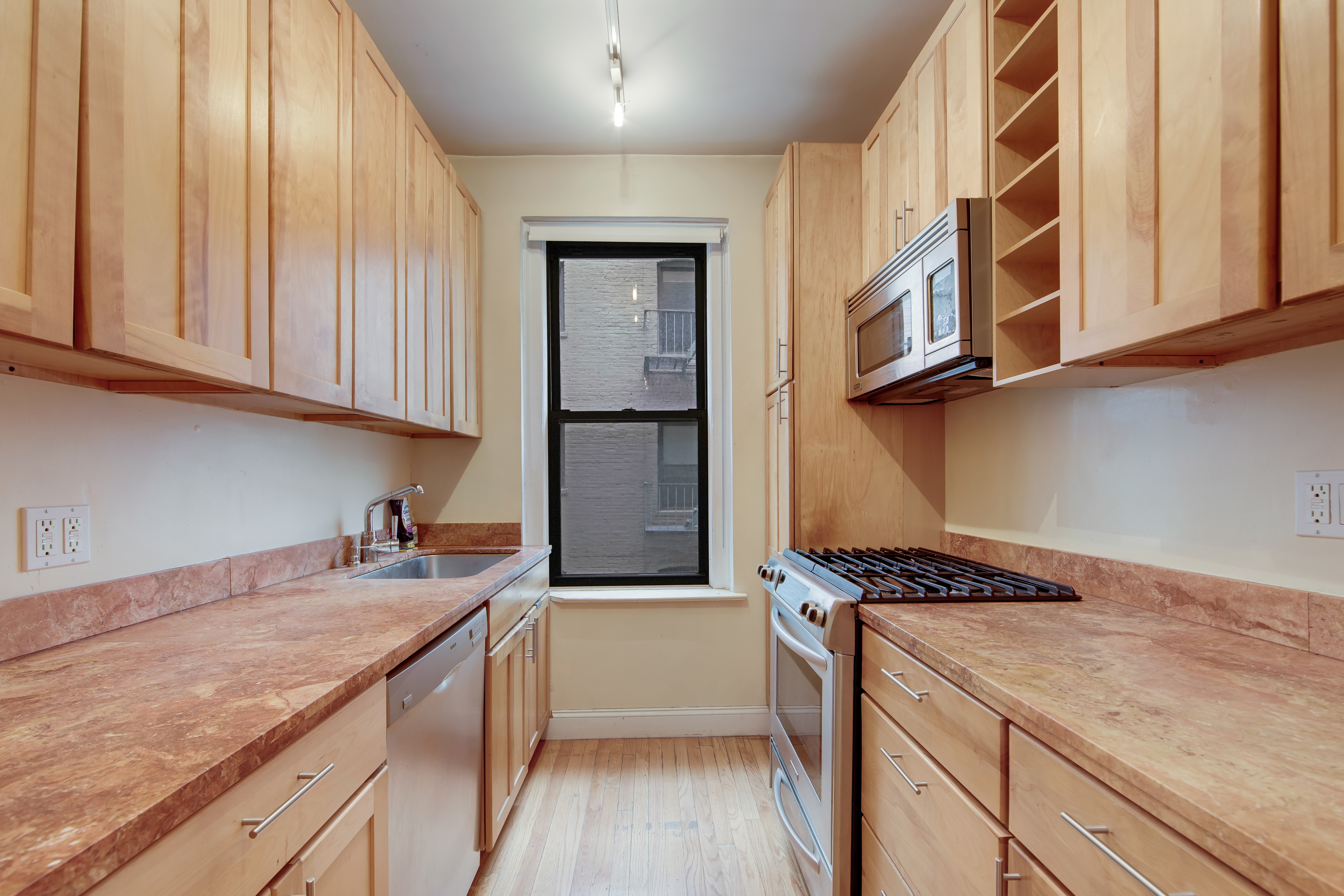 67 Morton Street, Unit 2B Manhattan, NY 10014 - Photo 3 of 12 a kitchen with stainless steel appliances granite countertop a stove and a sink
