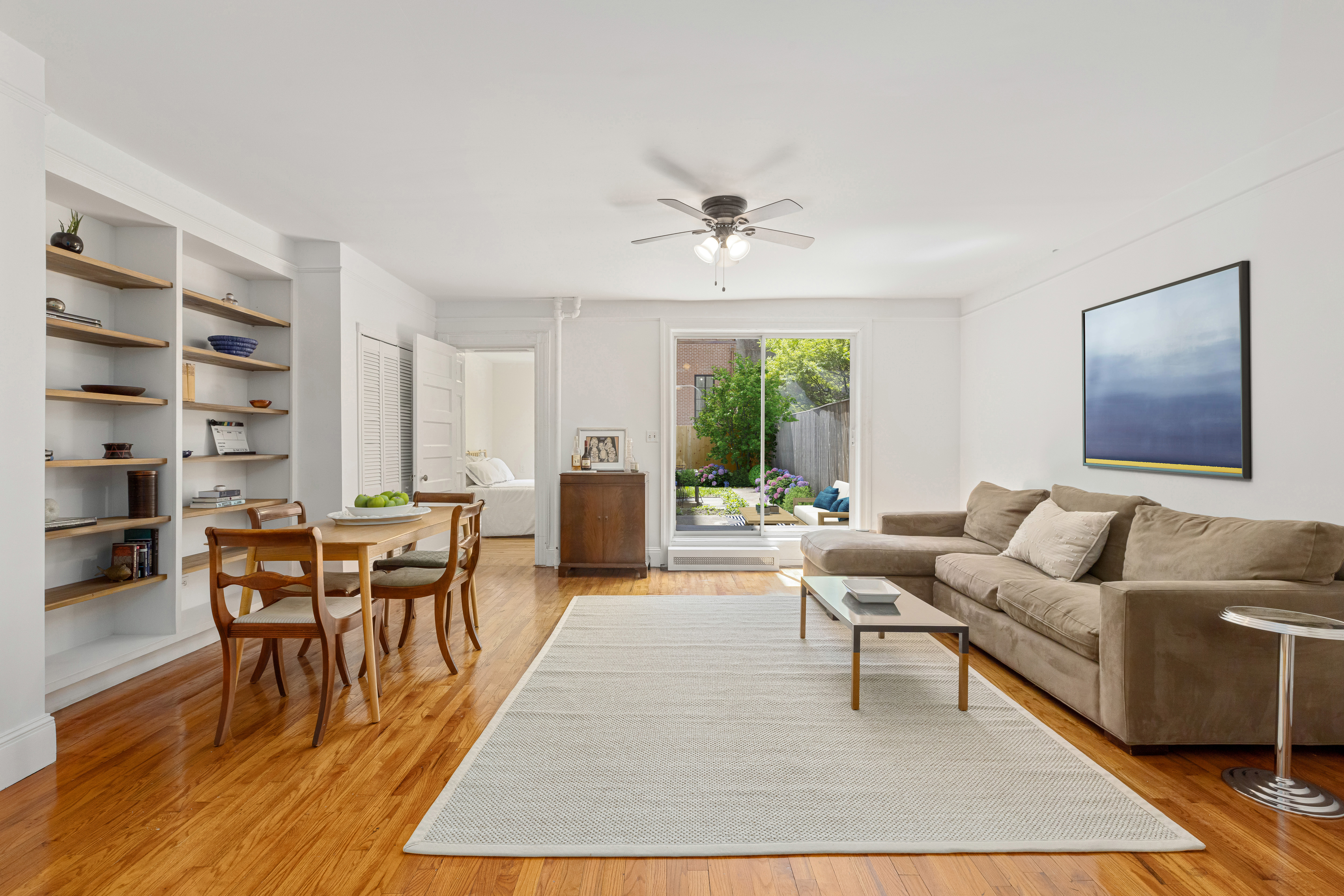 322 West 88th Street, Unit B Manhattan, NY 10024 - Photo 2 of 8 a living room with furniture a large window and a table