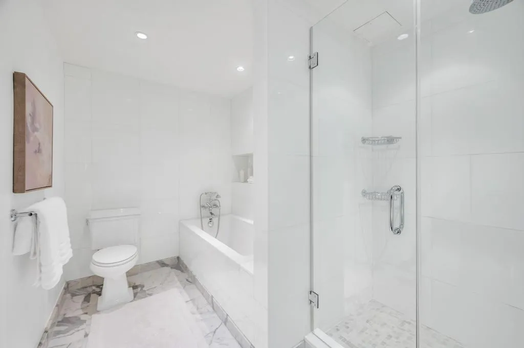 a bathroom with a toilet sink and shower