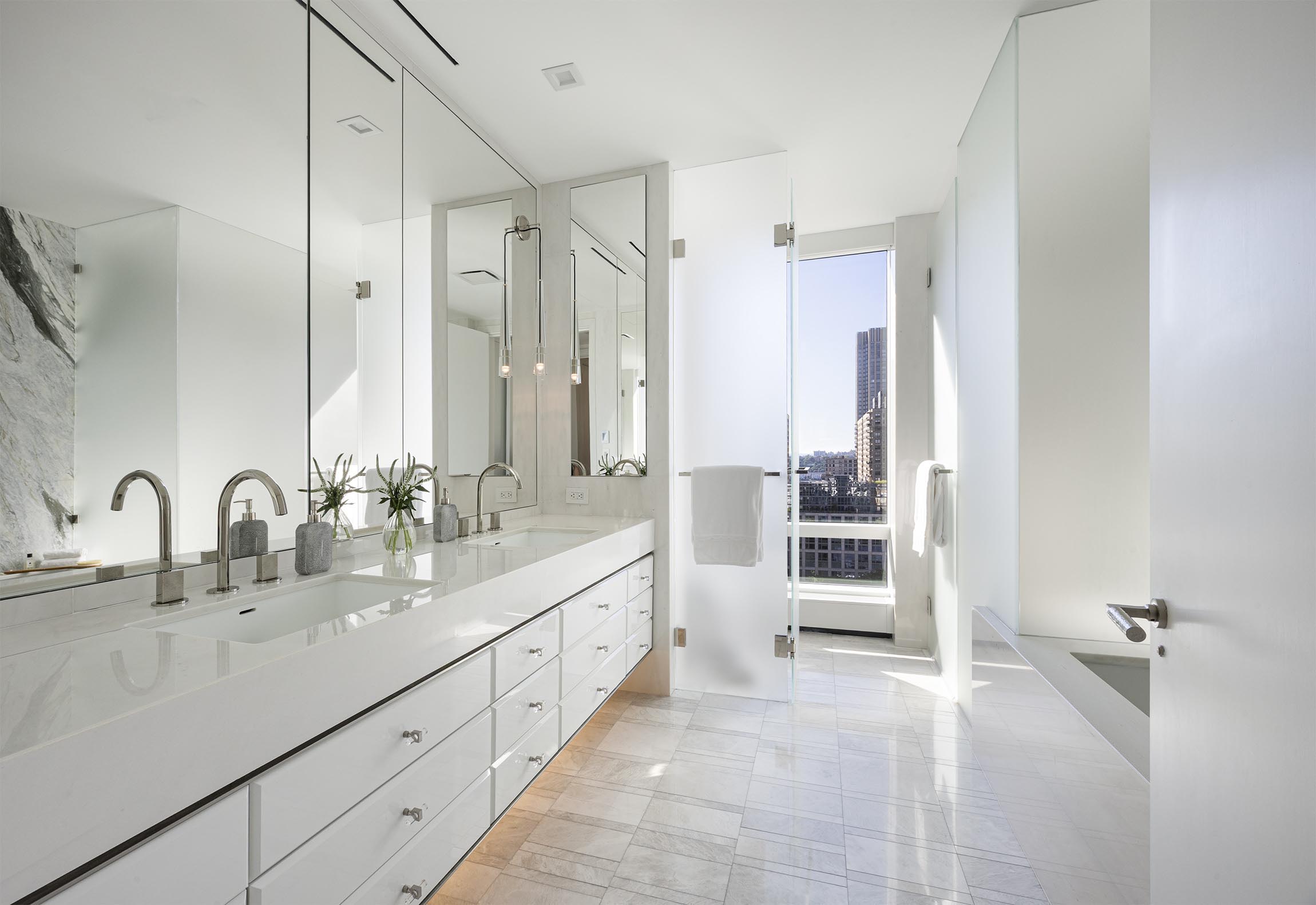 200 Amsterdam Avenue, Unit 17A Manhattan, NY 10023 - Photo 8 of 24 a bathroom with a double vanity sink a and a mirror