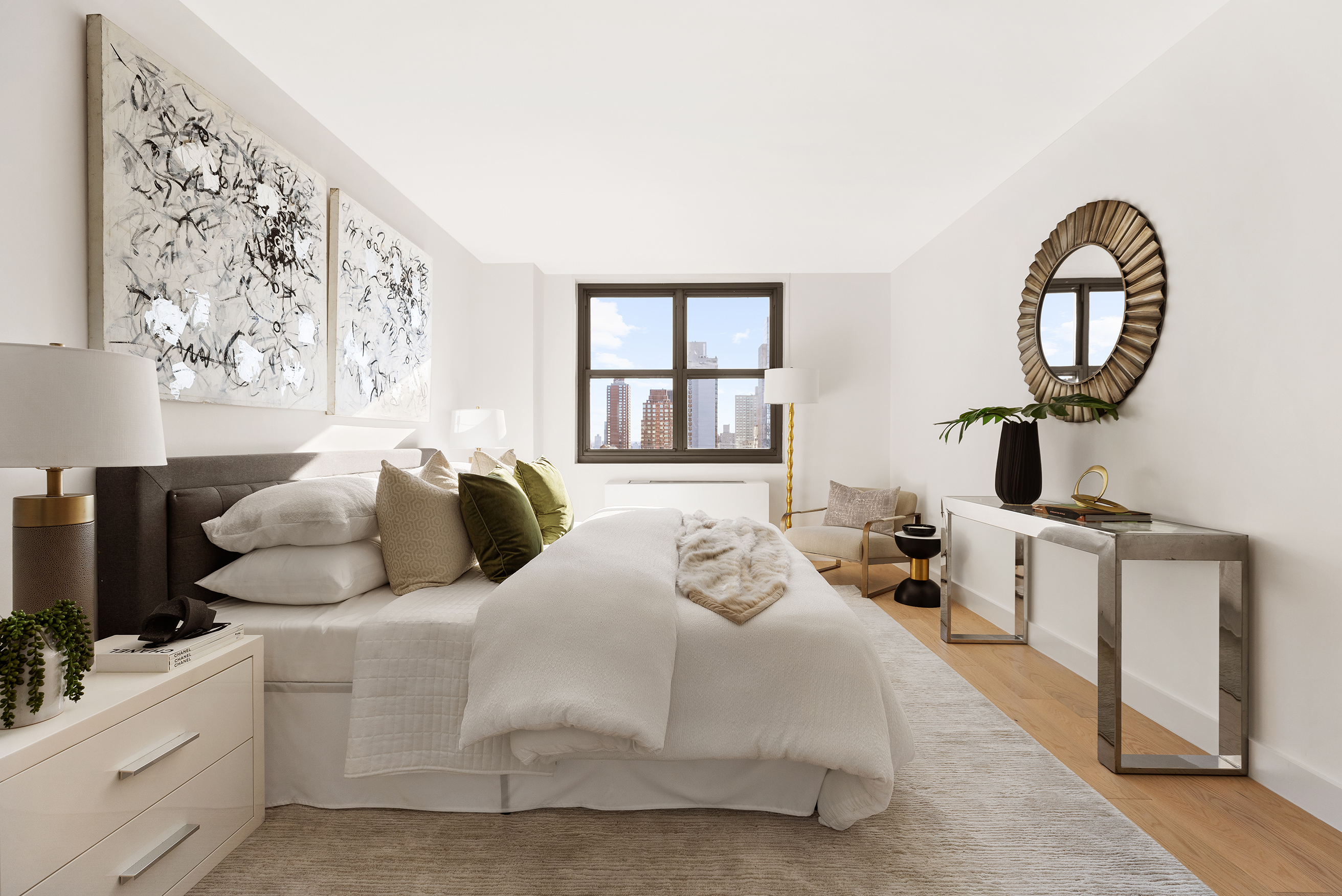 200 East 90th Street, Unit 12F Manhattan, NY 10128 - Photo 4 of 13 a bedroom with a large bed and a flat tv screen on the dresser