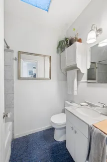 a bathroom with a sink a toilet and mirror