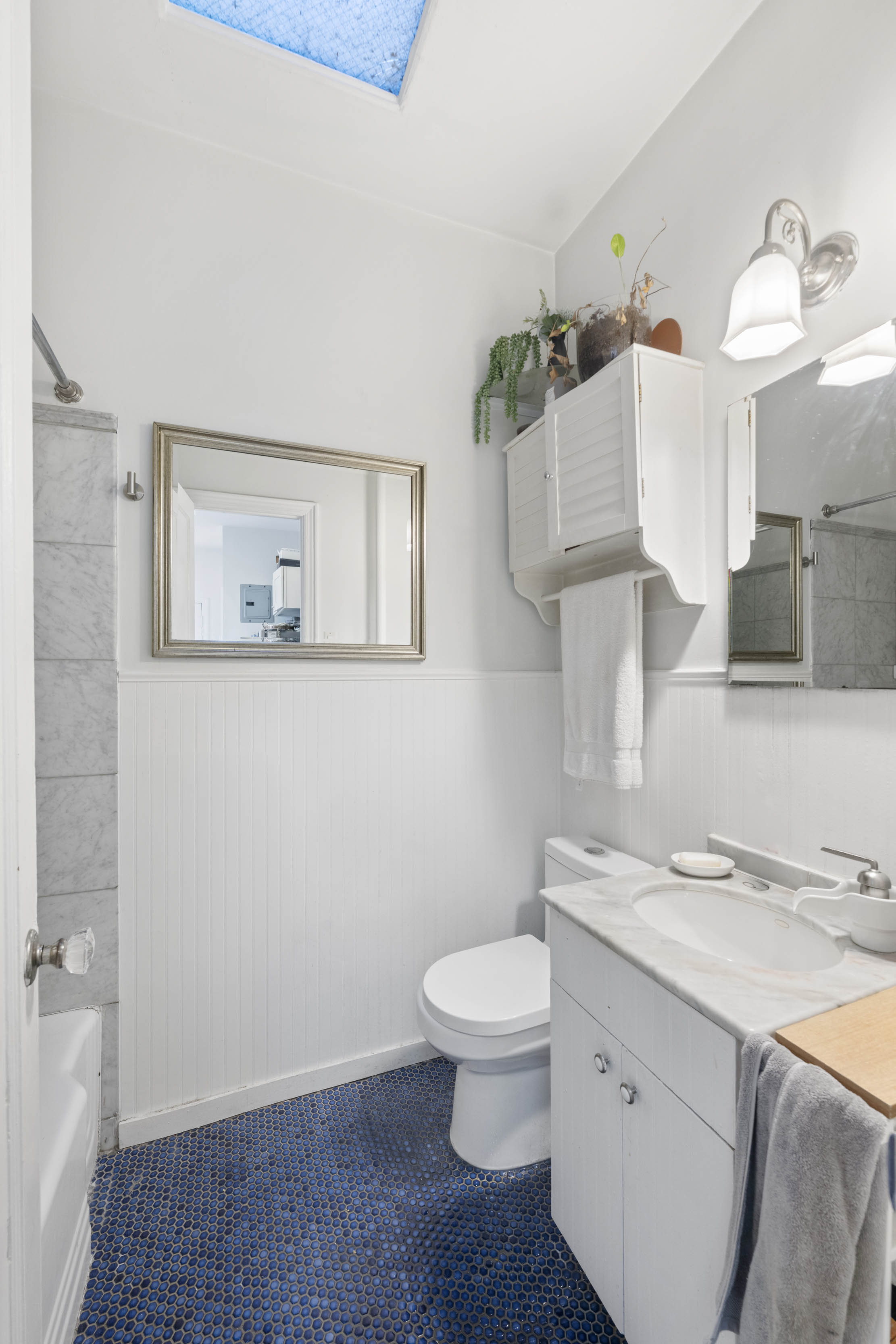 21 Monroe Place, Unit 5F Brooklyn, NY 11201 - Photo 7 of 10 a bathroom with a sink a toilet and mirror
