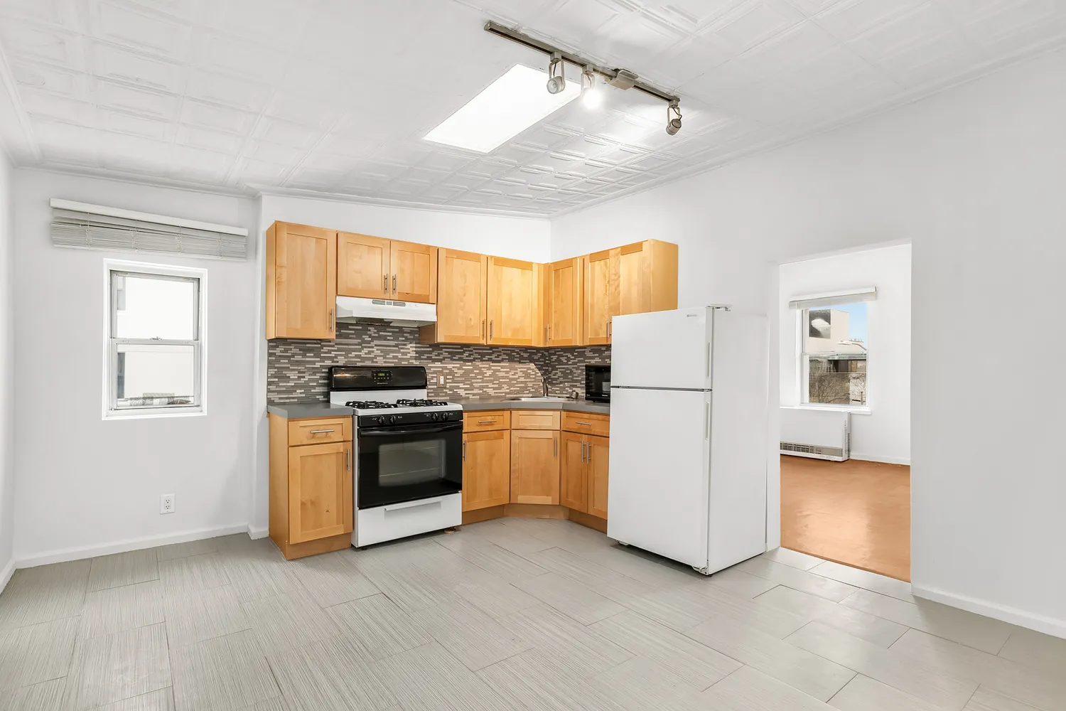 a kitchen with a refrigerator and a stove