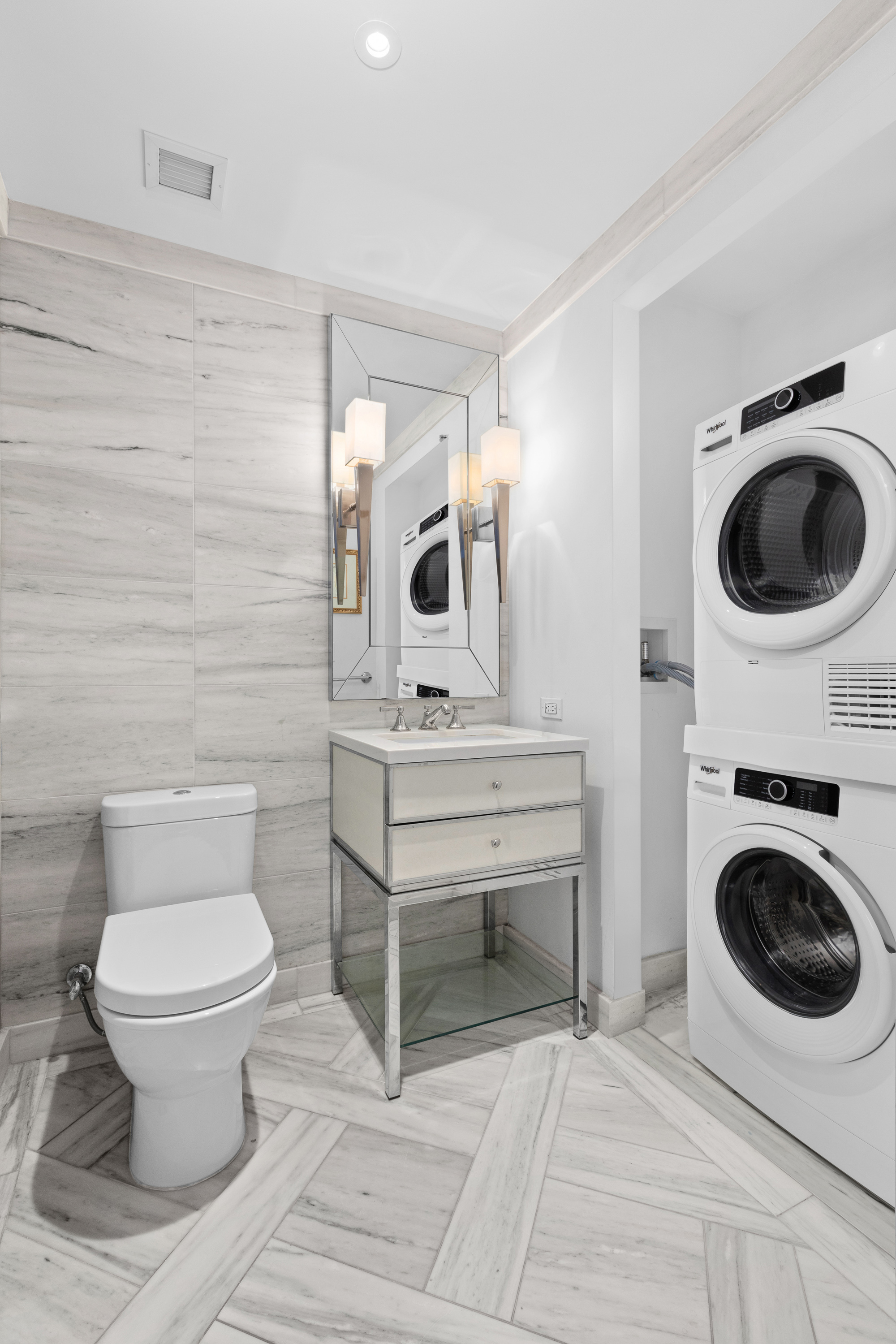 212 Warren Street, Unit 20A Manhattan, NY 10282 - Photo 19 of 23 a bathroom with a toilet a sink and a mirror