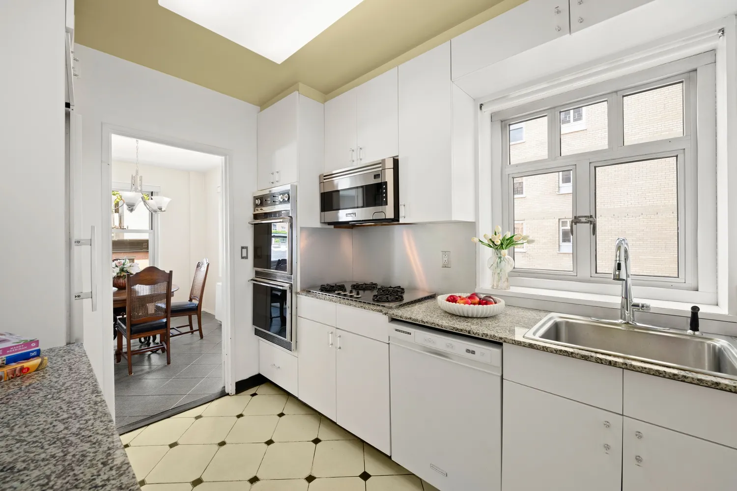 a kitchen with granite countertop a sink stove and cabinets