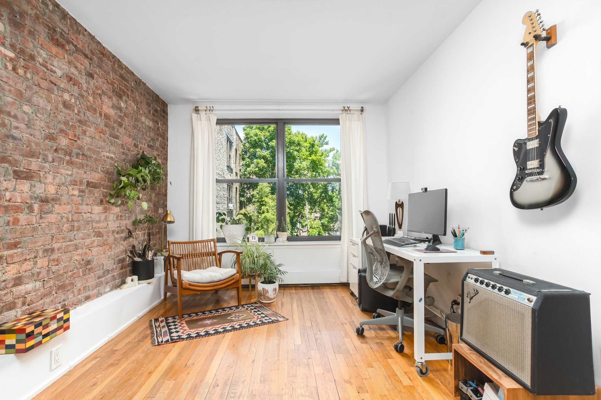 427 St Johns Place, Unit 2B Brooklyn, NY 11238 - Photo 8 of 11 a living room with furniture a window and a potted plant