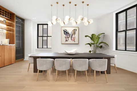 a dining room table chairs and window