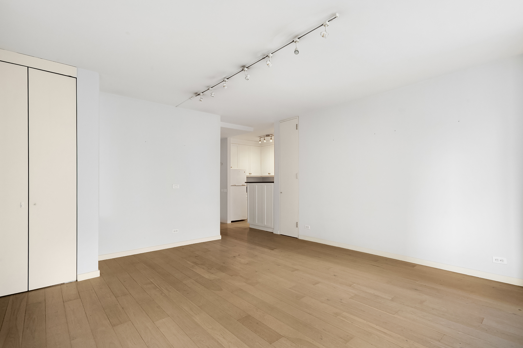 330 East 75th Street, Unit 3L Manhattan, NY 10021 - Photo 11 of 14 an empty room with wooden floor and windows