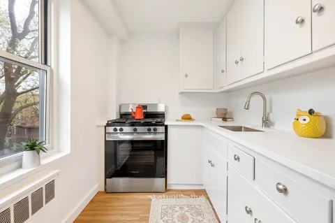 a kitchen with cabinets and window