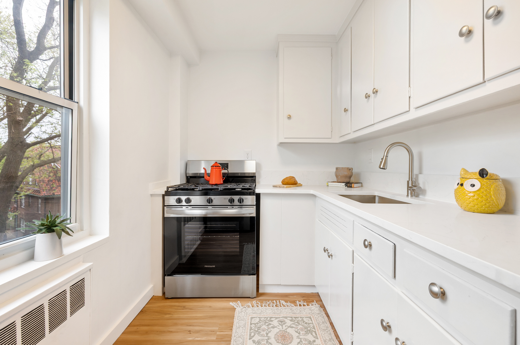 35-51 85th Street, Unit 4K Queens, NY 11372 - Photo 6 of 11 a kitchen with cabinets and window