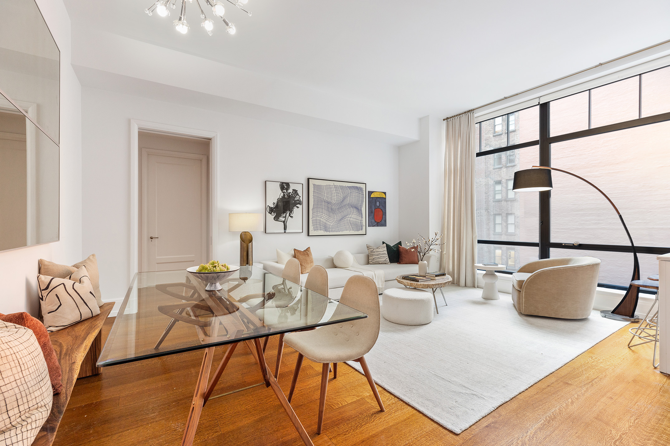 10 Madison Square West, Unit 7A Manhattan, NY 10010 - Photo 2 of 8 a living room with furniture a window and a table