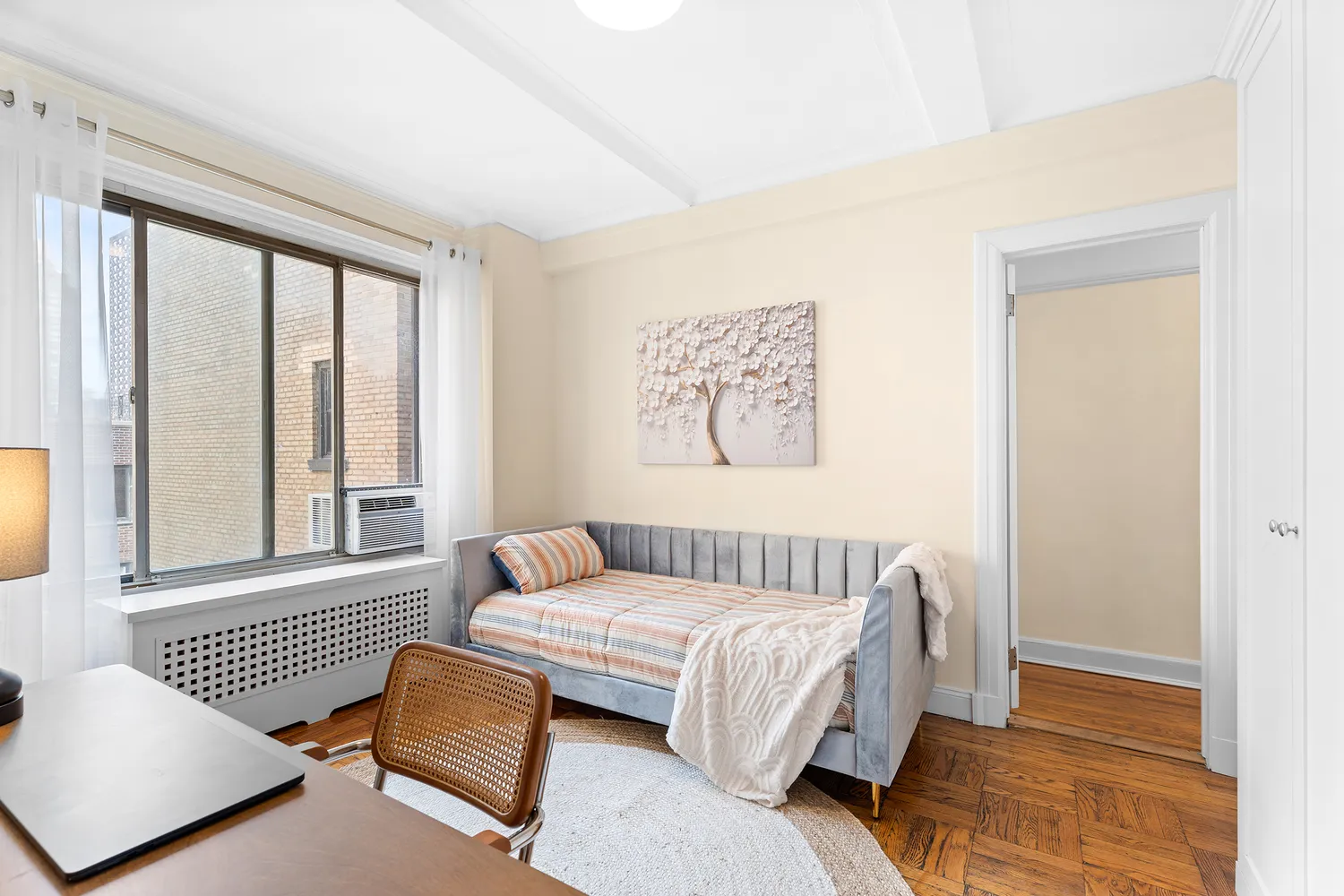 a bedroom with furniture and a window