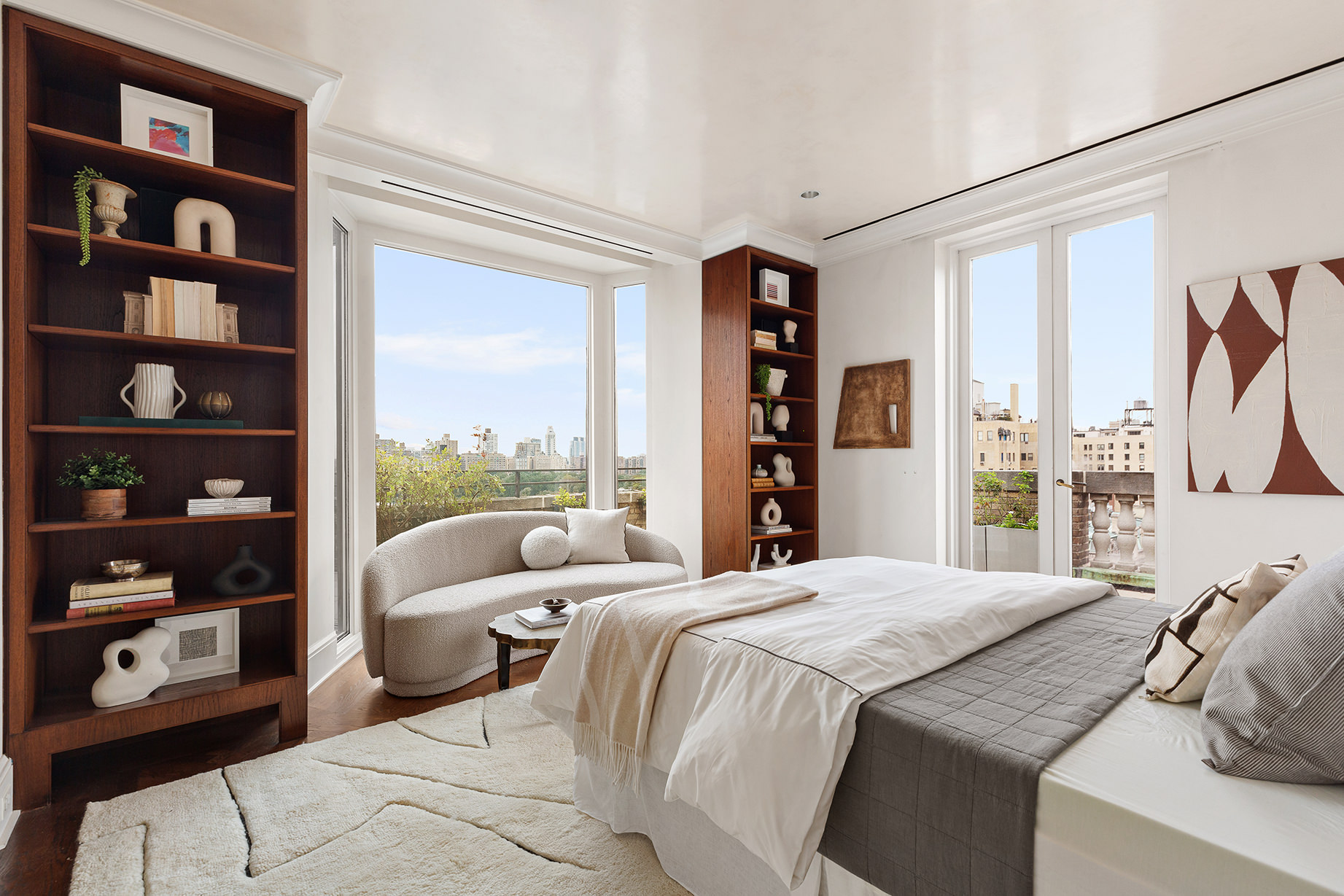 14 East 90th Street, Unit PHW Manhattan, NY 10128 - Photo 13 of 25 a bedroom with a bed a large window and book shelf