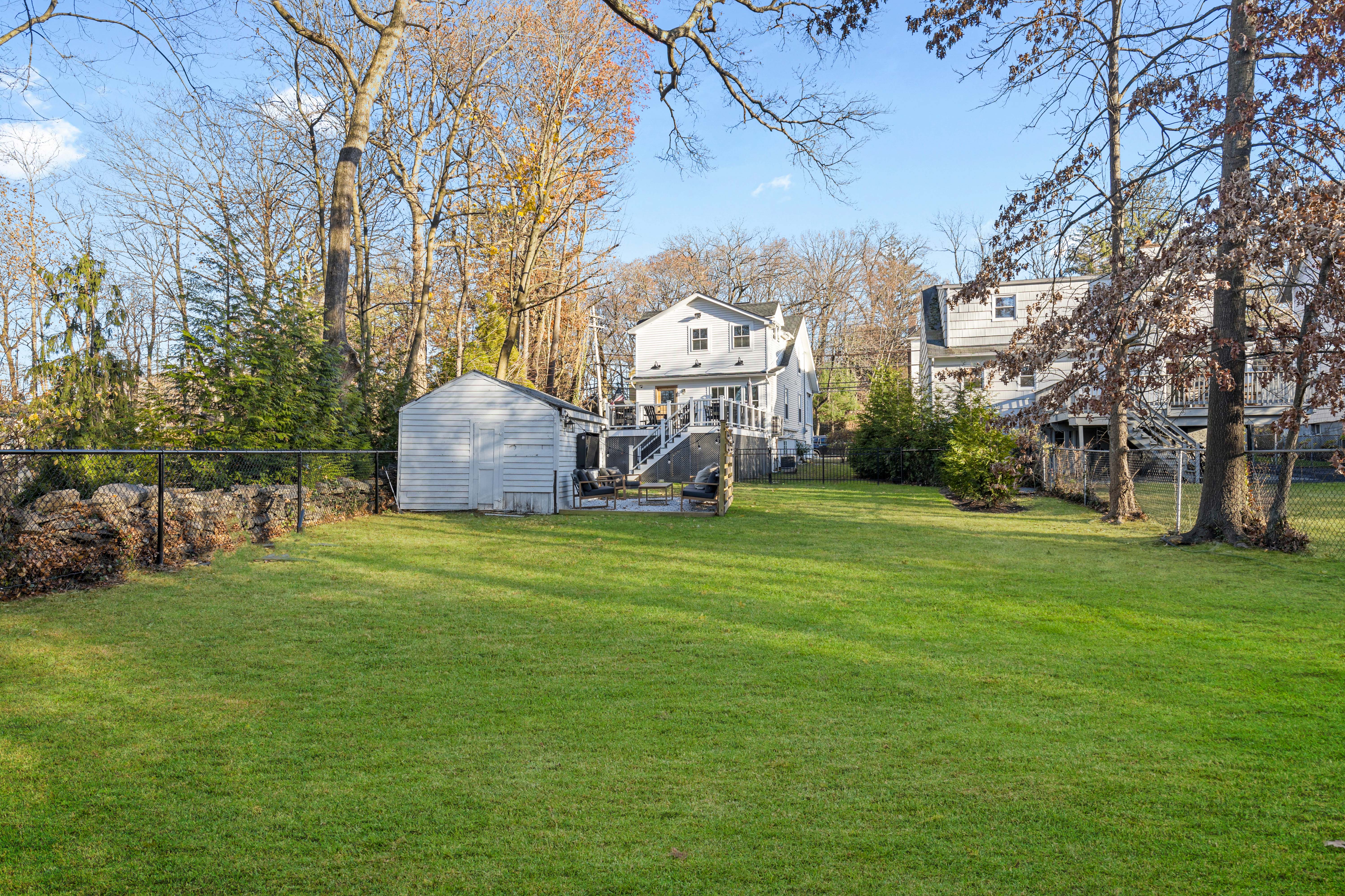 467 Midland Avenue Rye, NY 10580 - Photo 18 of 19 a backyard of a house with table and chairs