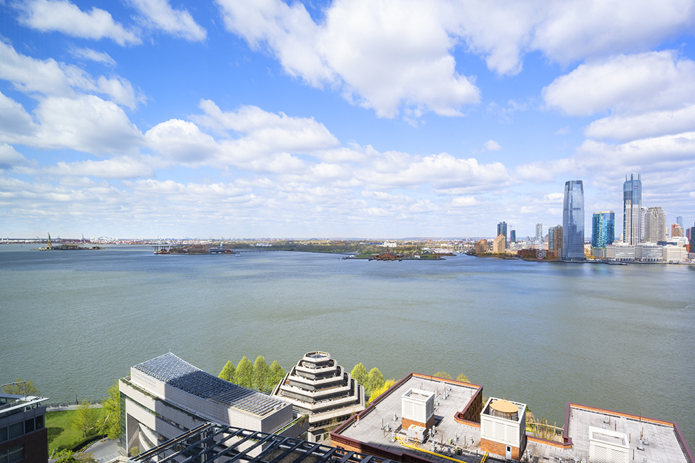 30 West Street, Unit 21AB Manhattan, NY 10004 - Photo 2 of 17 a view of a lake from a balcony
