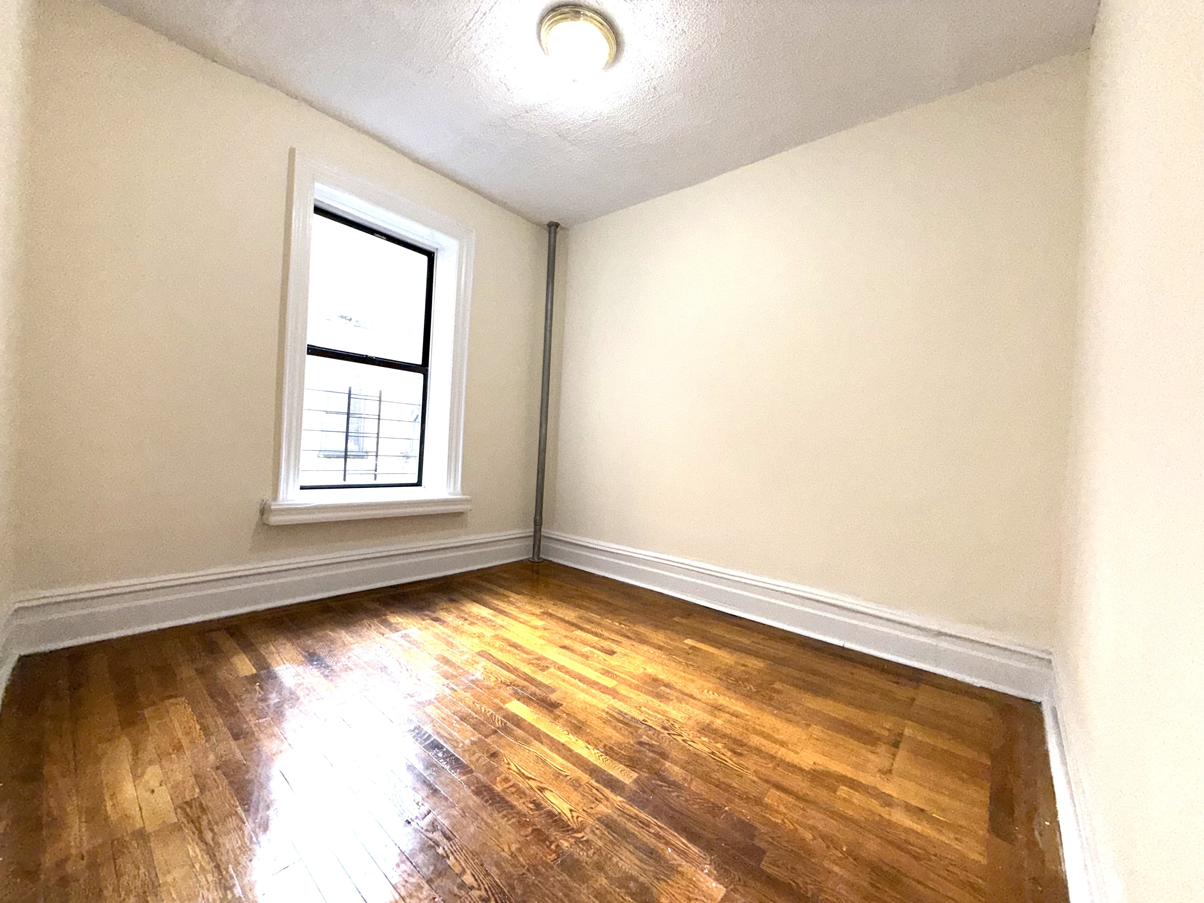 153 Vermilyea Avenue, Unit 4B Manhattan, NY 10034 - Photo 6 of 9 a view of an empty room and window