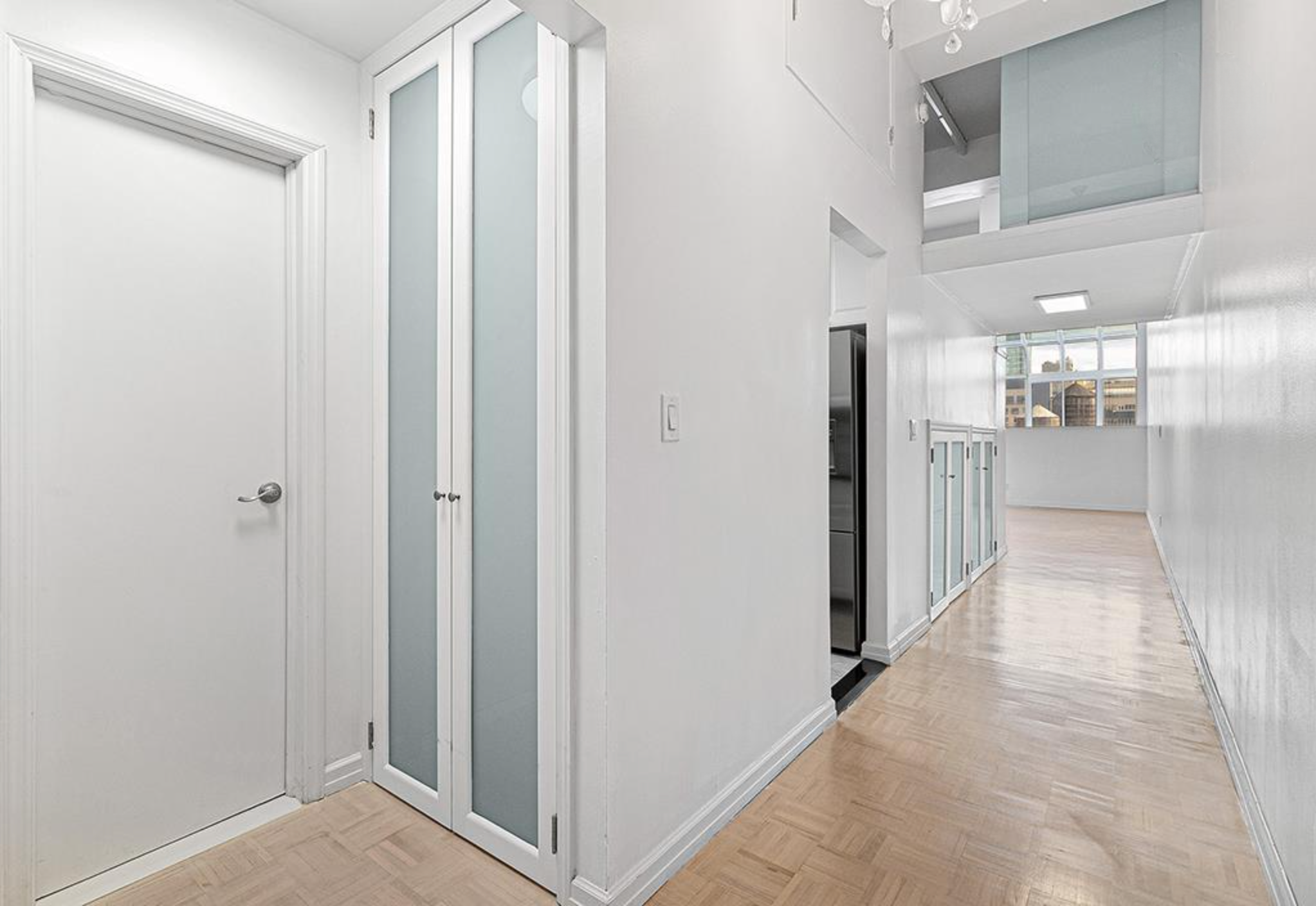 310 East 46th Street, Unit 19F Manhattan, NY 10017 - Photo 13 of 17 a view of a hallway with a wooden cabinets
