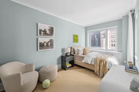 a bedroom with bed and a couch