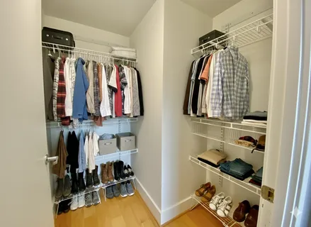 a view of a hallway with wooden floor and furniture