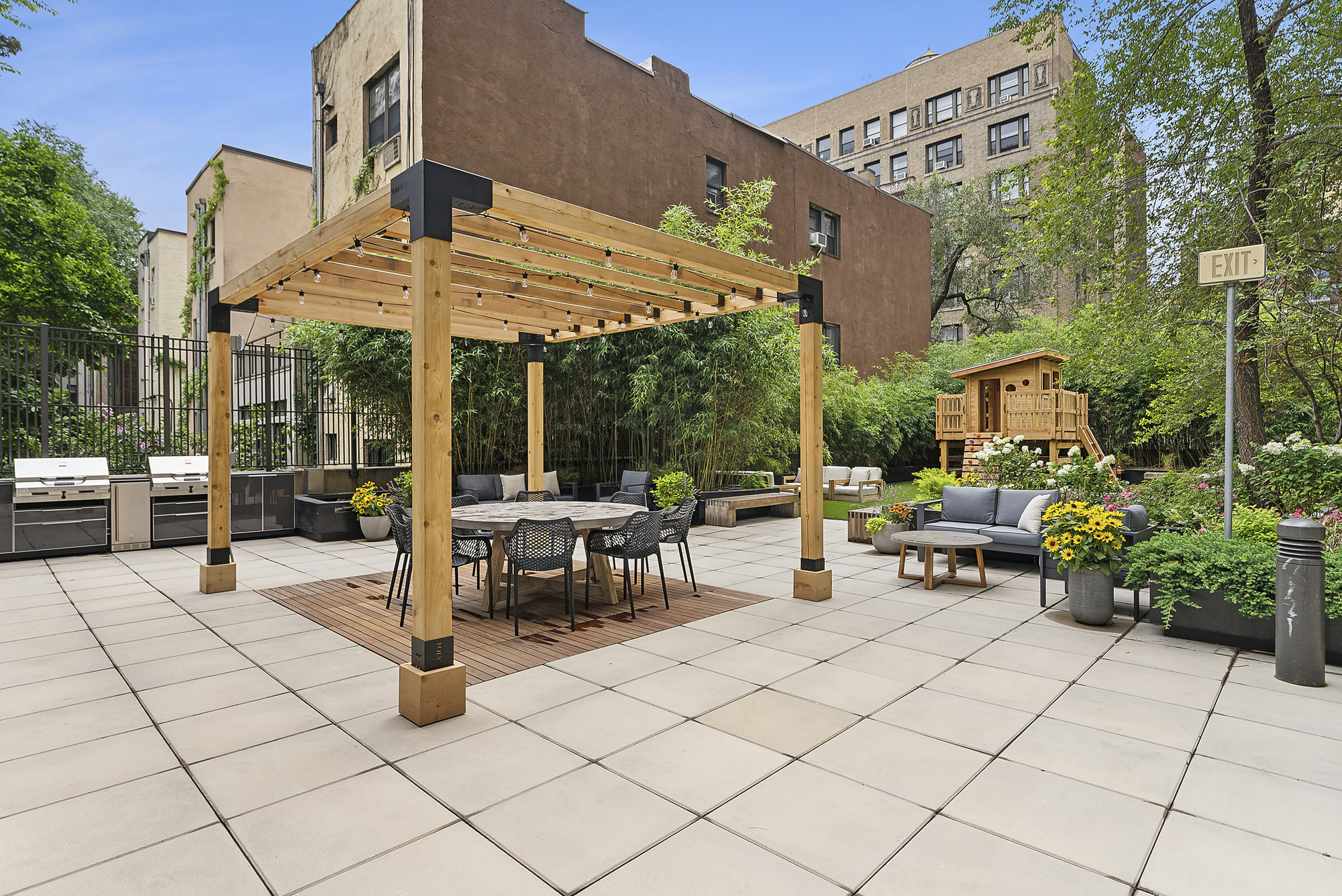 175 West 95th Street, Unit 18G Manhattan, NY 10025 - Photo 9 of 14 a view of a patio with table and chairs potted plants and a large tree