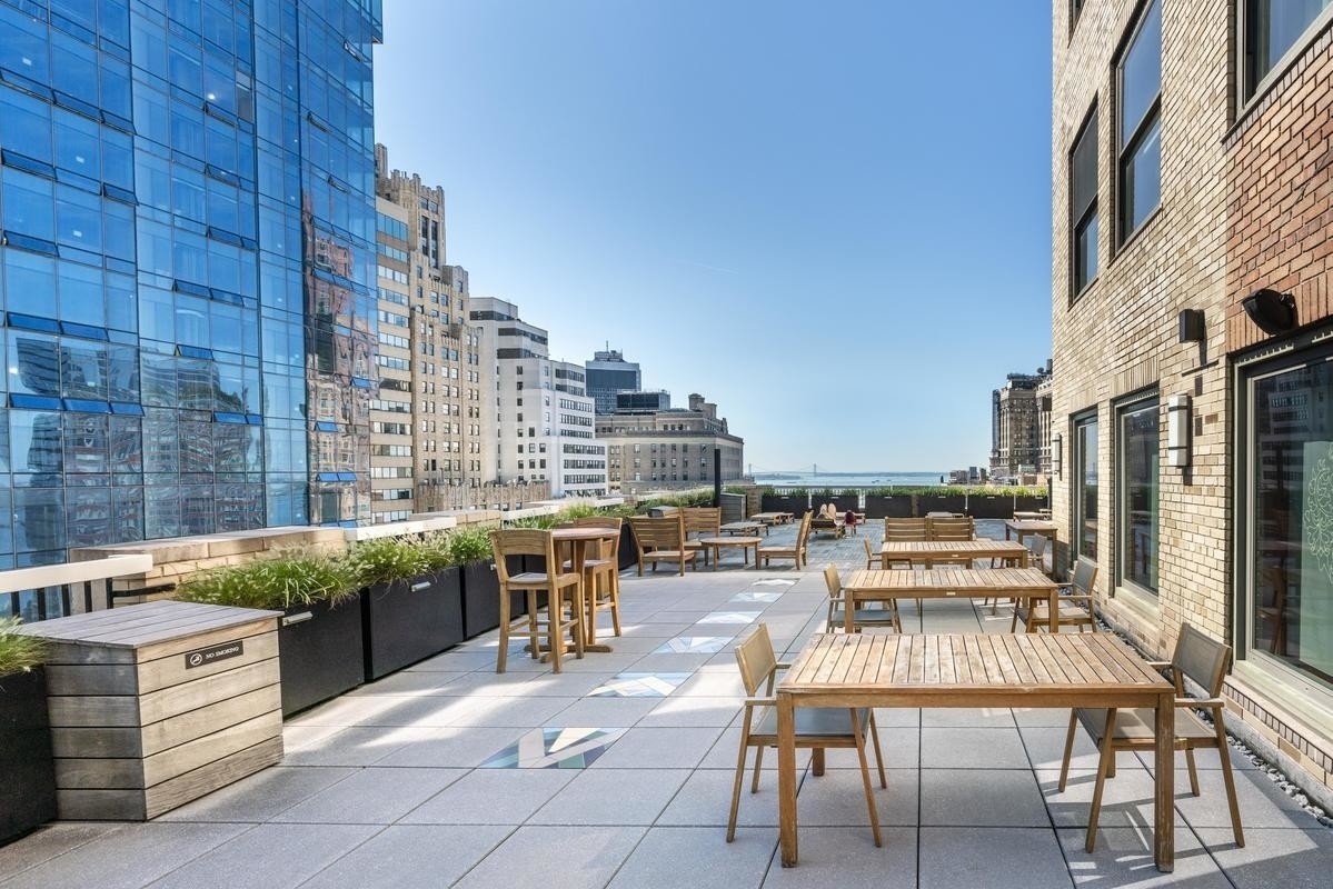 88 Greenwich Street, Unit 611 Manhattan, NY 10006 - Photo 2 of 10 a terrace with outdoor seating and city view