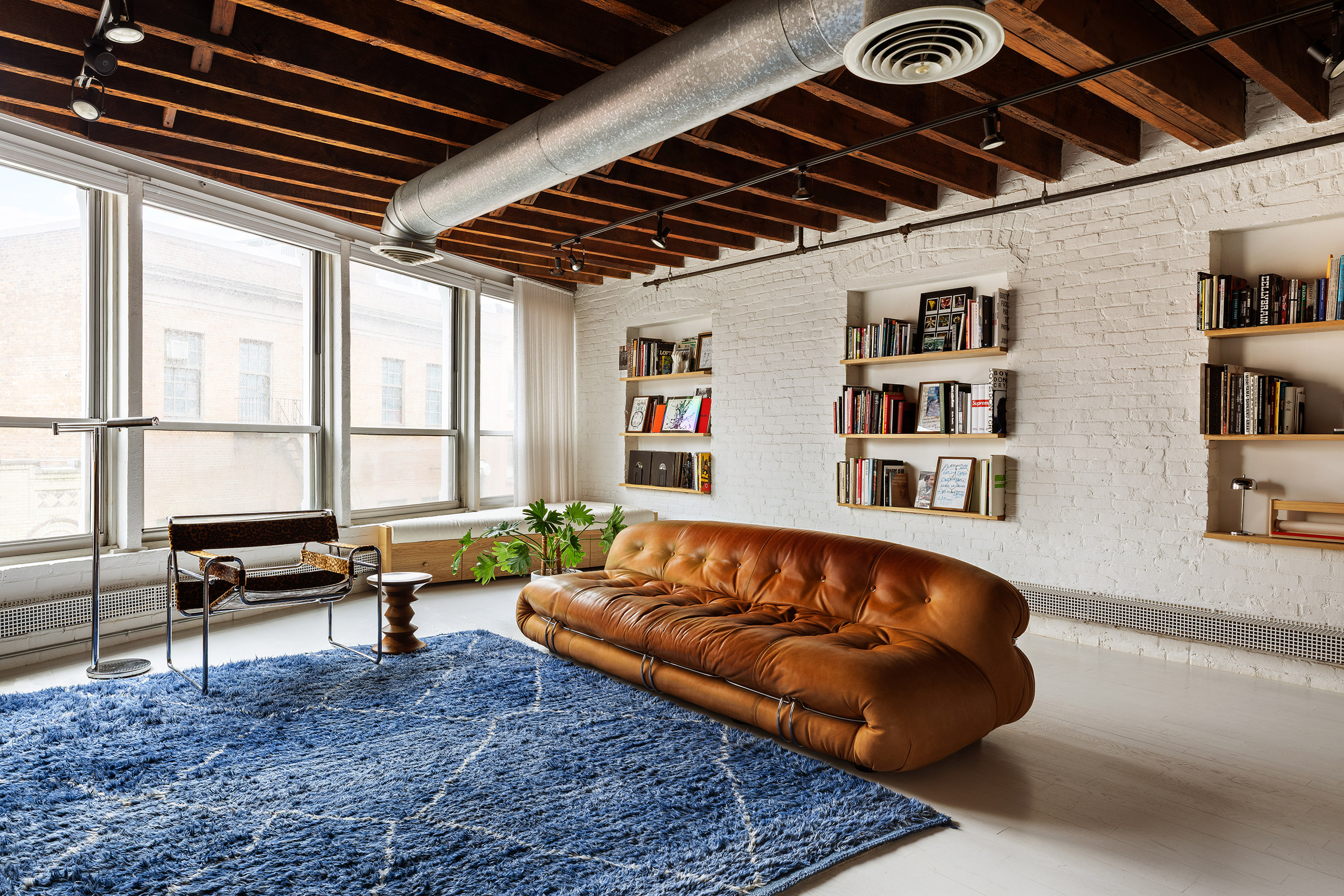 a living room with a couch and a book shelf
