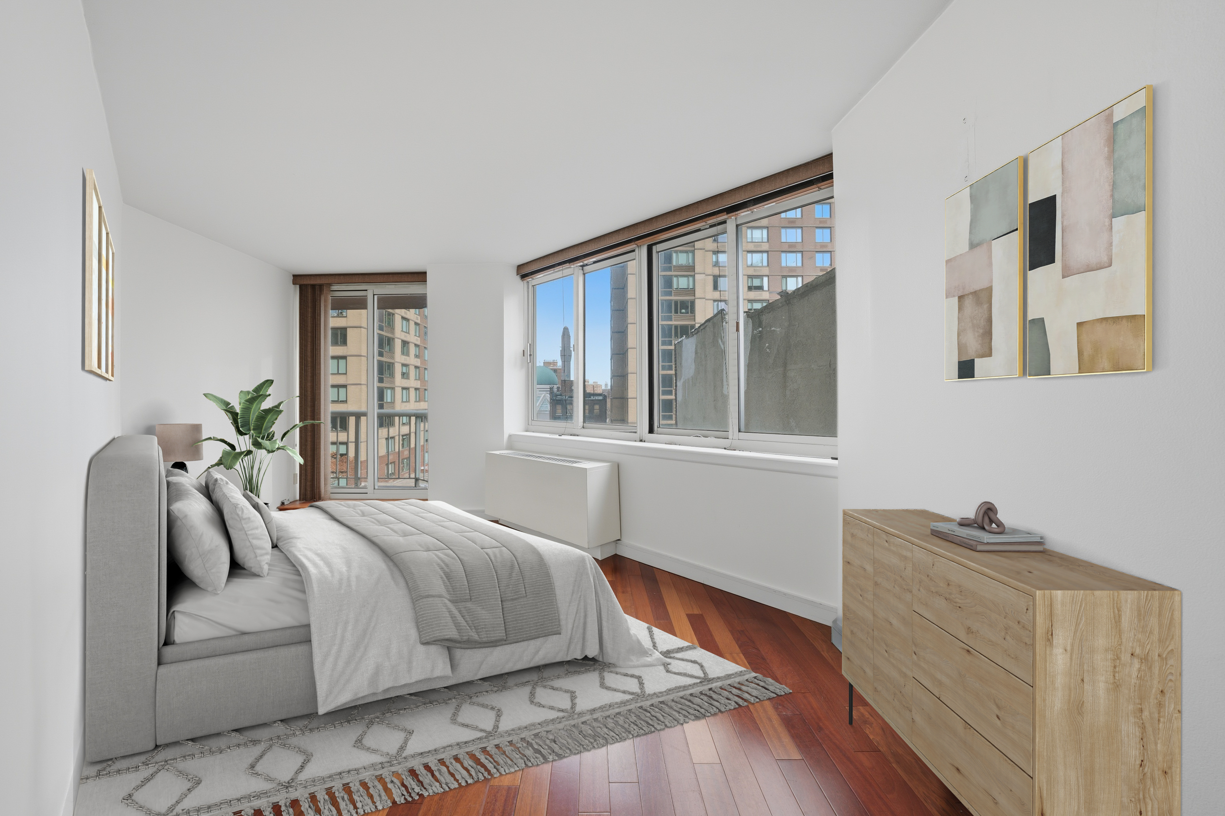 206 East 95th Street, Unit 6B Manhattan, NY 10128 - Photo 12 of 25 a bedroom with a bed and wooden floor