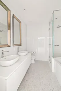a bathroom with a bathtub sink mirror and toilet