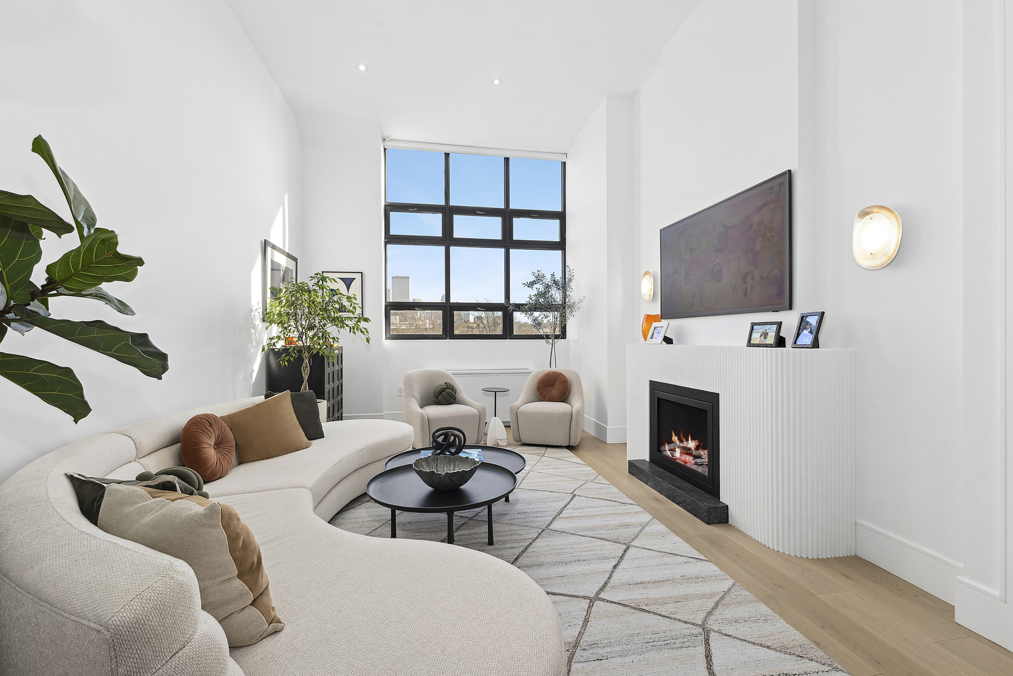 360 Furman Street, Unit 508 Brooklyn, NY 11201 - Photo 3 of 28 a living room with furniture a fireplace and a potted plant