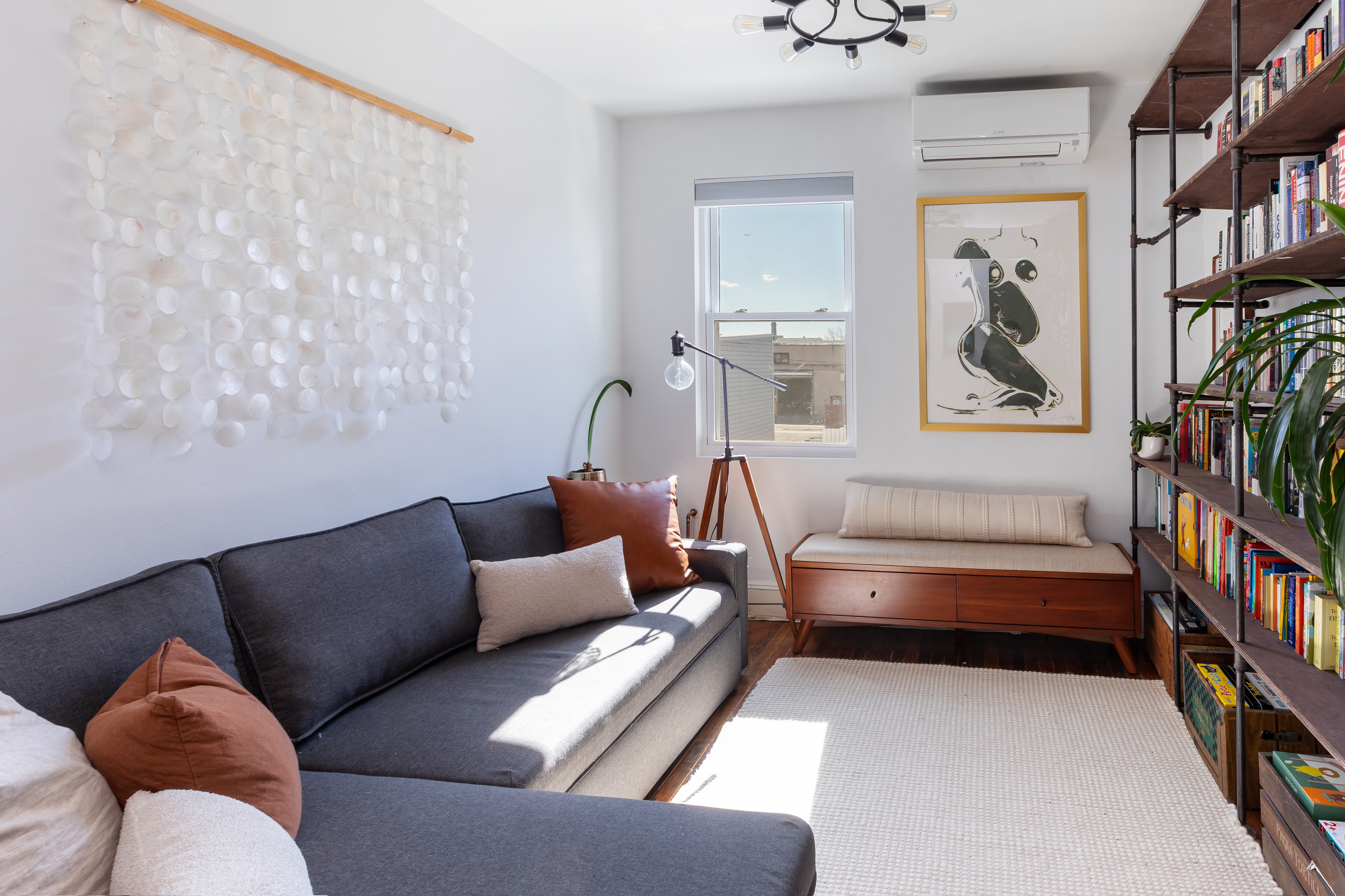 214 Eagle Street Brooklyn, NY 11222 - Photo 12 of 22 a living room with furniture and a book shelf