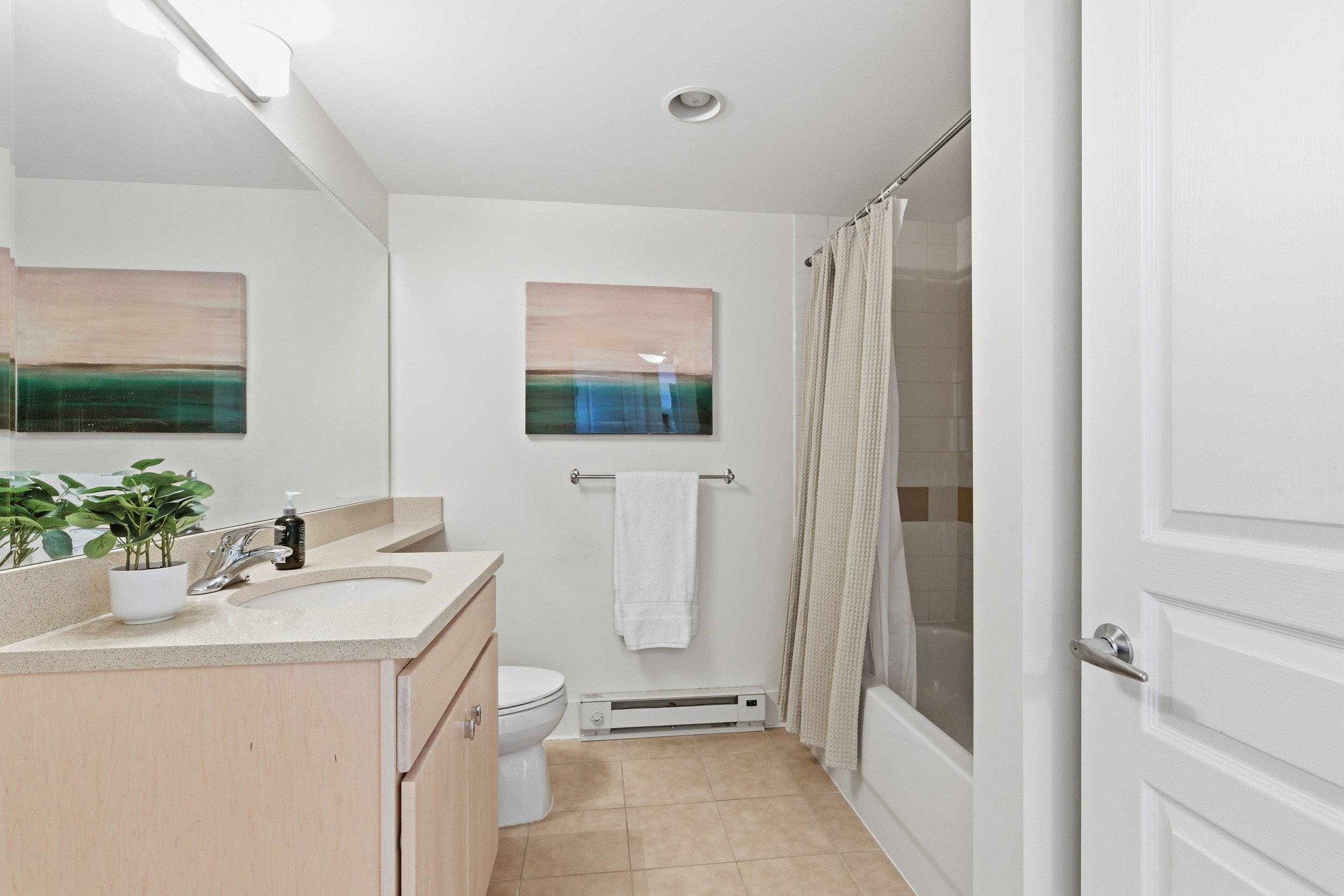Repton Circle, Unit 3204 Watertown, MA 02472 - Photo 15 of 18 a bathroom with a sink a mirror a vanity and a shower