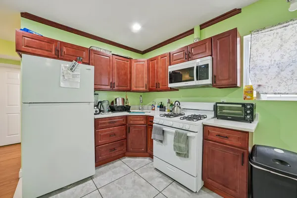 a kitchen with a stove top oven sink and refrigerator