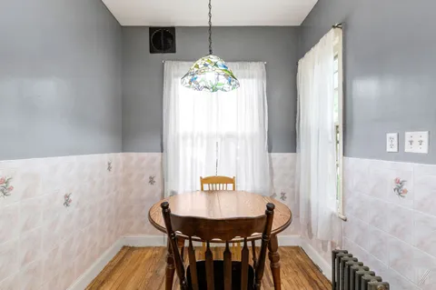 a view of a dining room with furniture and window