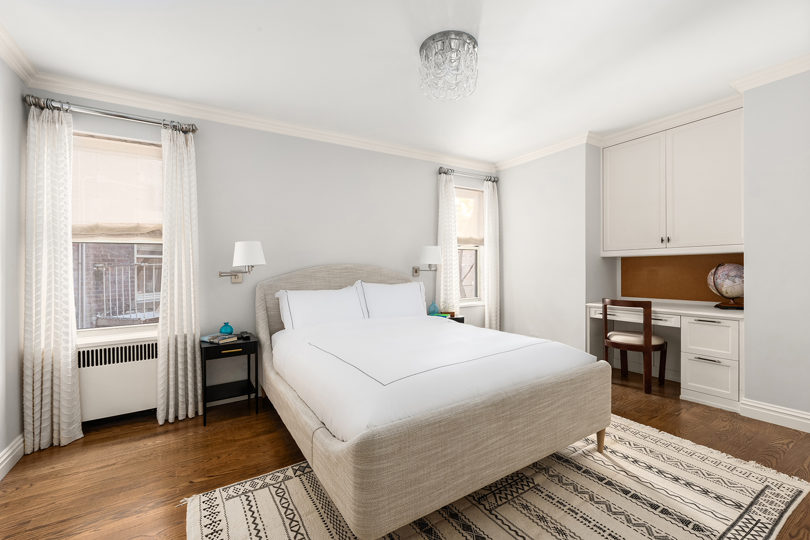 75 Bank Street, Unit 2H Manhattan, NY 10014 - Photo 9 of 18 a bedroom with a bed and a flat screen tv